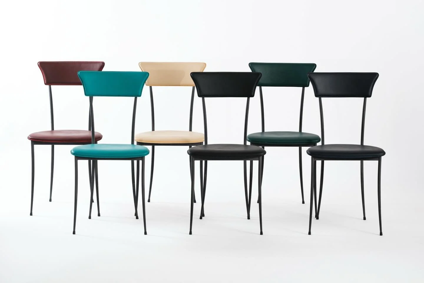 (SOLD) Dining Chairs by Arper Italy, 1980s &mdash; Set of 6

Arper made chairs that understood the assignment: get out of the way and let the leather do the talking. Slender black steel legs, a round cushioned seat, and that signature trapezoid backr