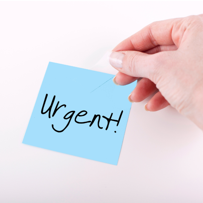 A hand peeling a blue sticky note with the word "Urgent!" written on it in black marker.