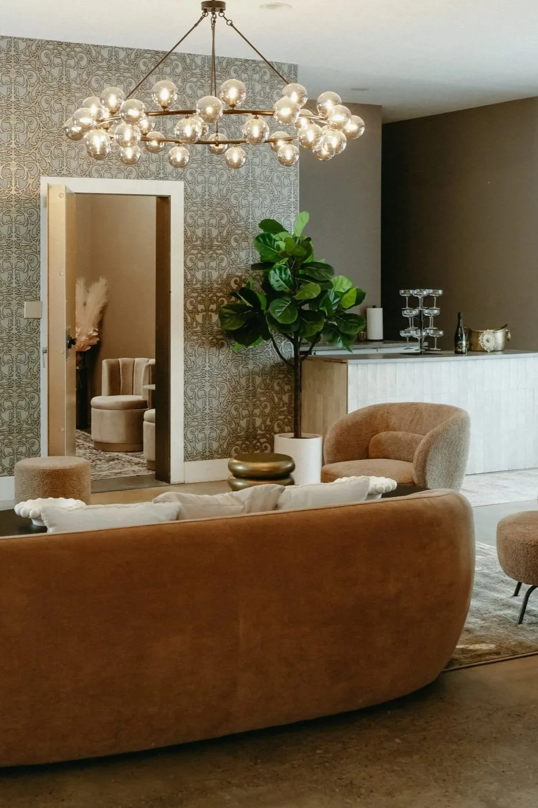 Interior area featuring couch, chairs, and bar.