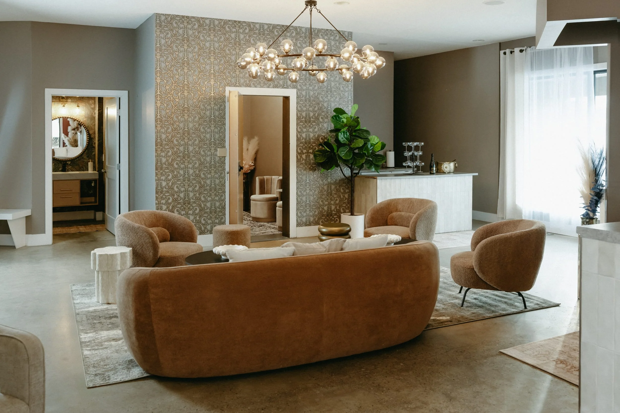 Interior space featuring a couch, chairs, and bar.