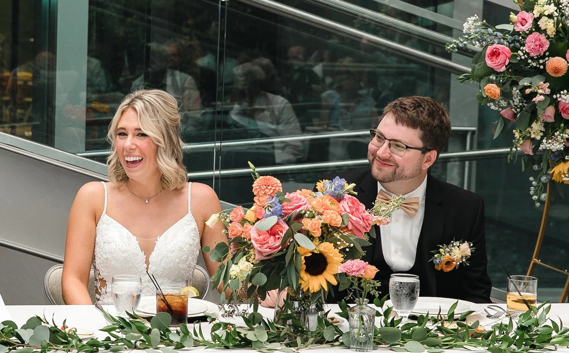 Happy Couple Newly Married sitting at their head table.  Wedding Planner & Day of Coordination Services