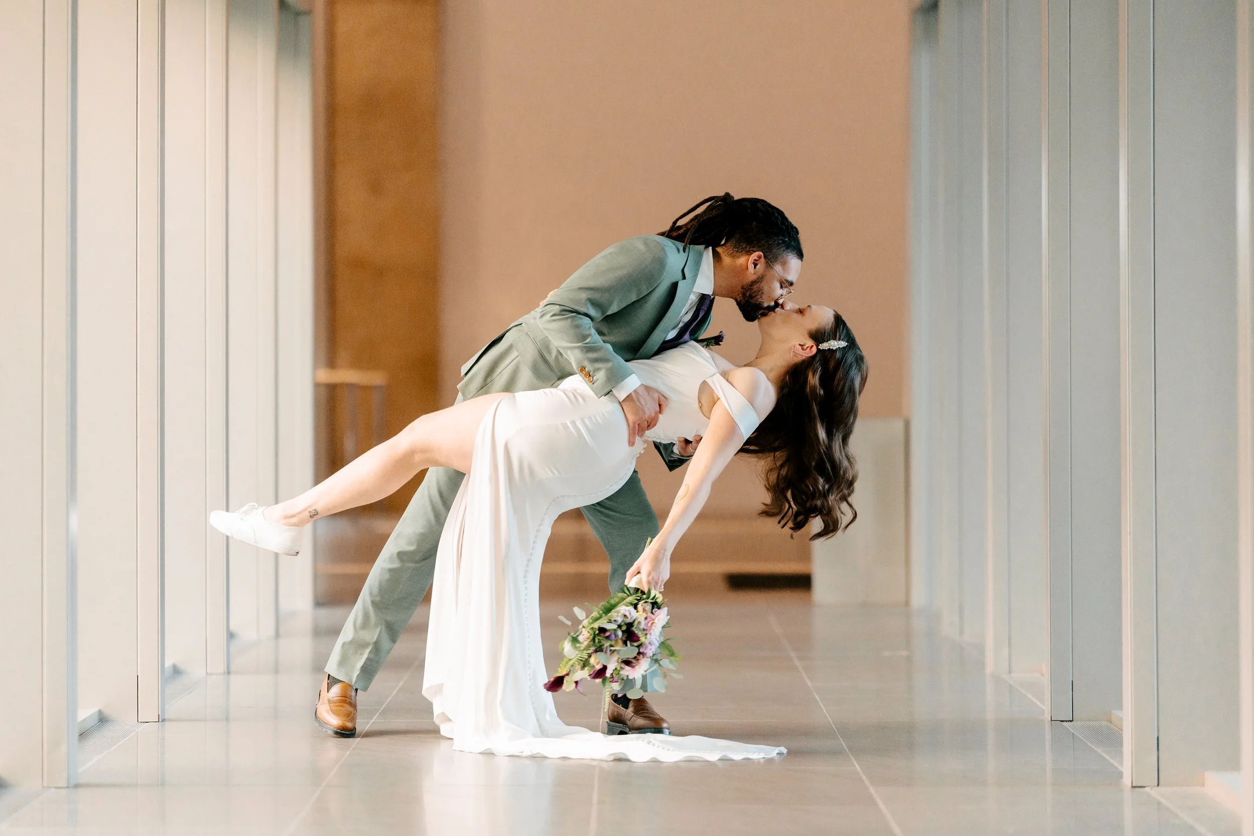 Newly married couple doing a dip kiss. Wedding Planner & Day of Coordination Services