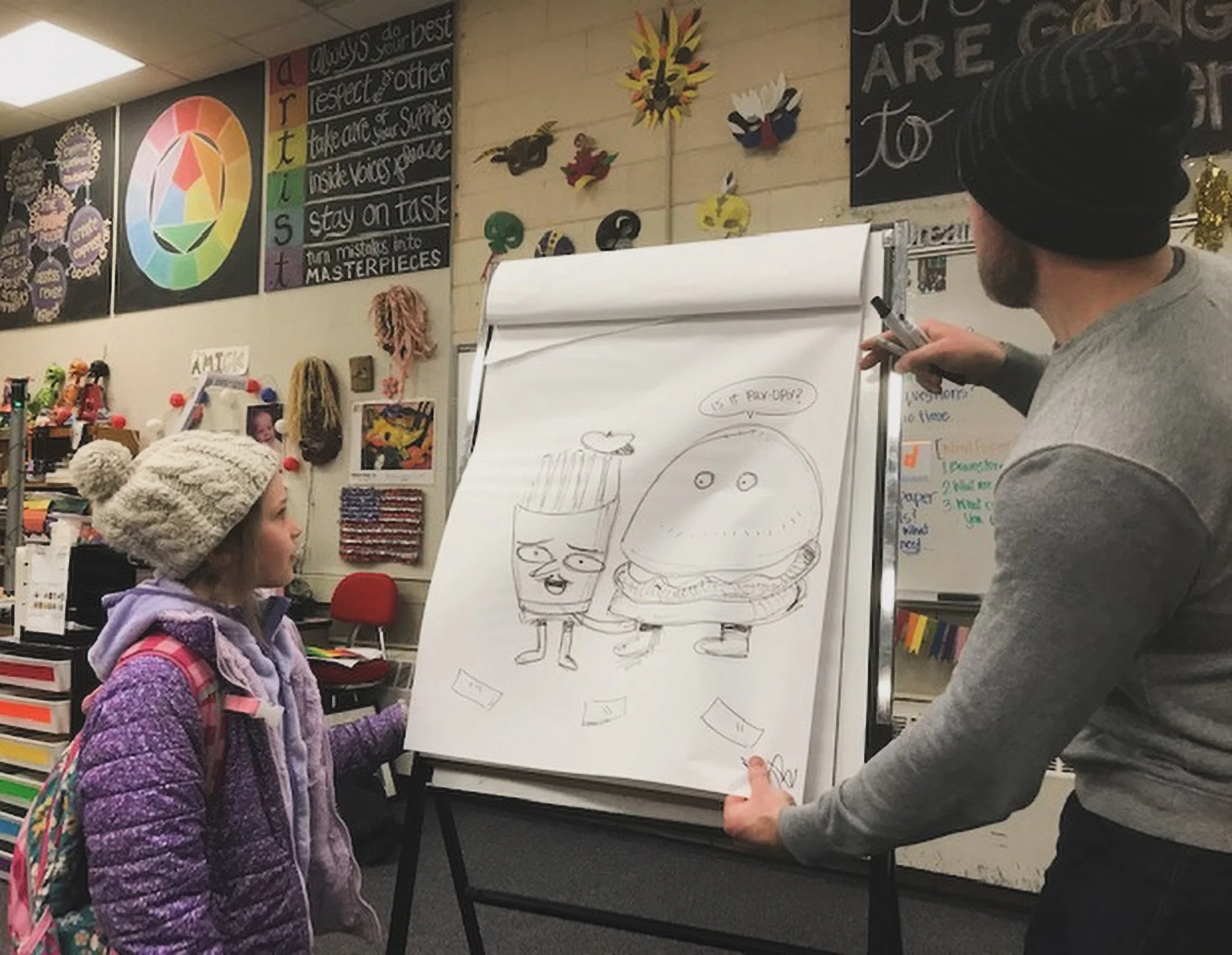 Greg drawing with a little girl