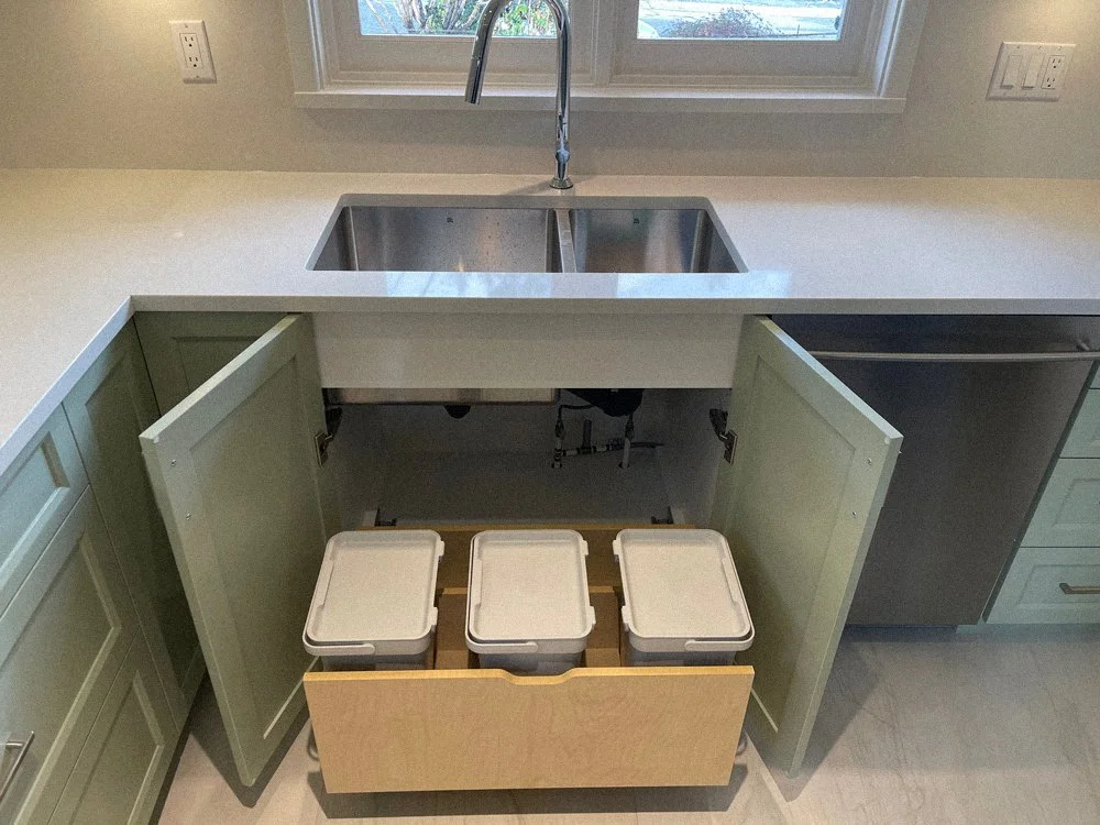 Under-sink custom cabinetry with integrated waste and recycling storage, custom kitchen millwork