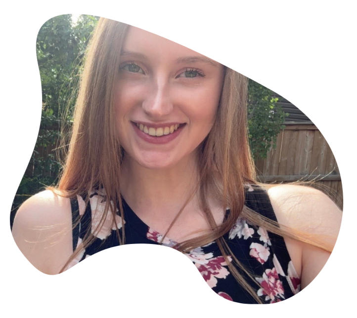 Imogen has a big smile, outside and has long blonde hair.