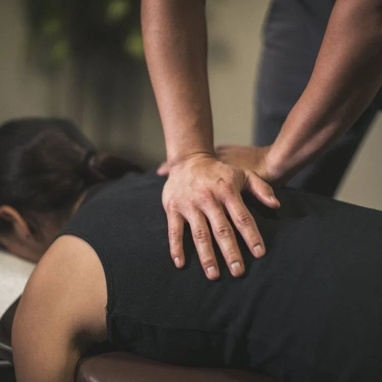 Person receiving a back massage from a massage therapist.