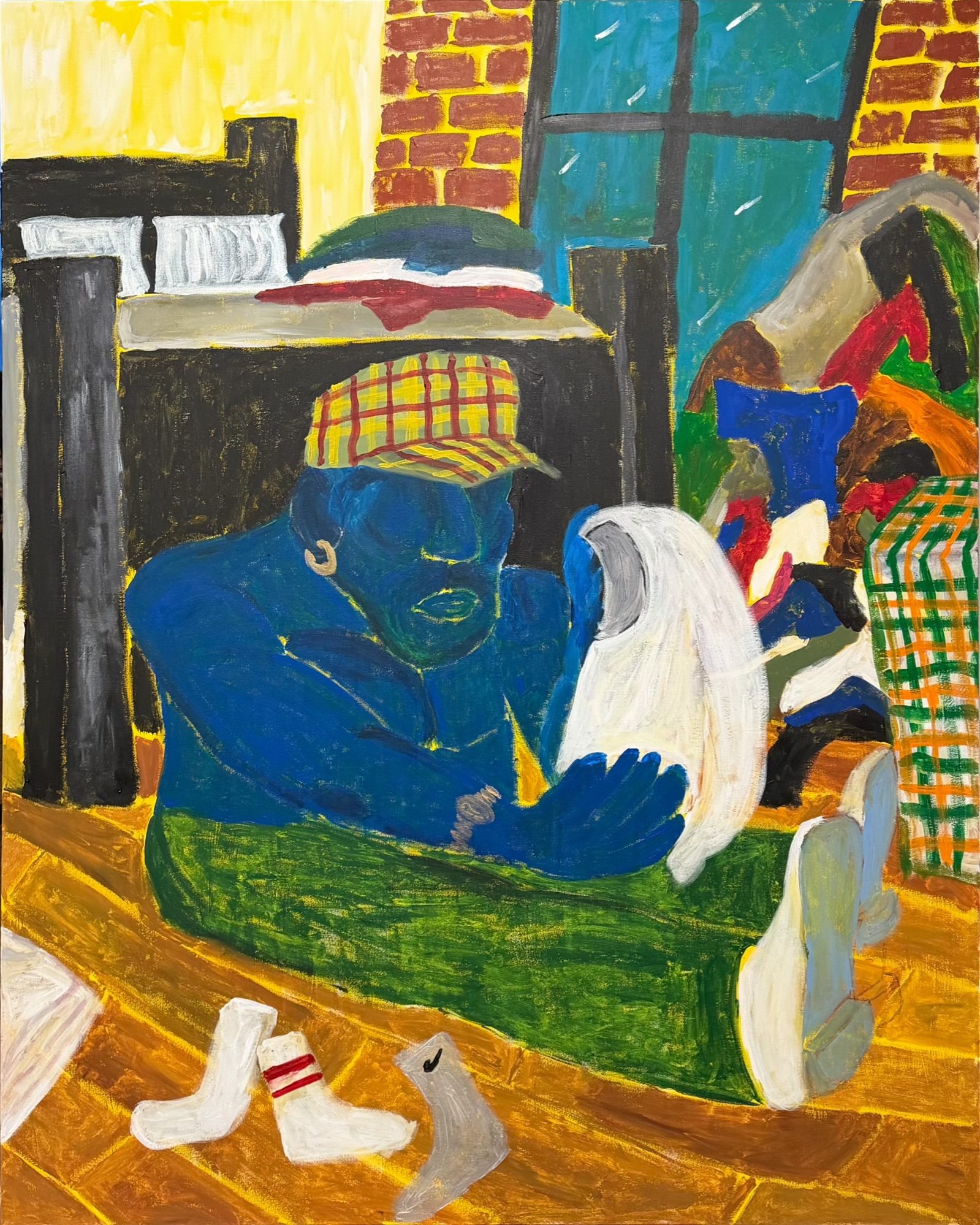 Colorful painting of a room with a person sitting at a table, wearing white socks with red stripes, with a white mug and a green rug in the foreground, a bed with pillows, a window, and colorful walls.