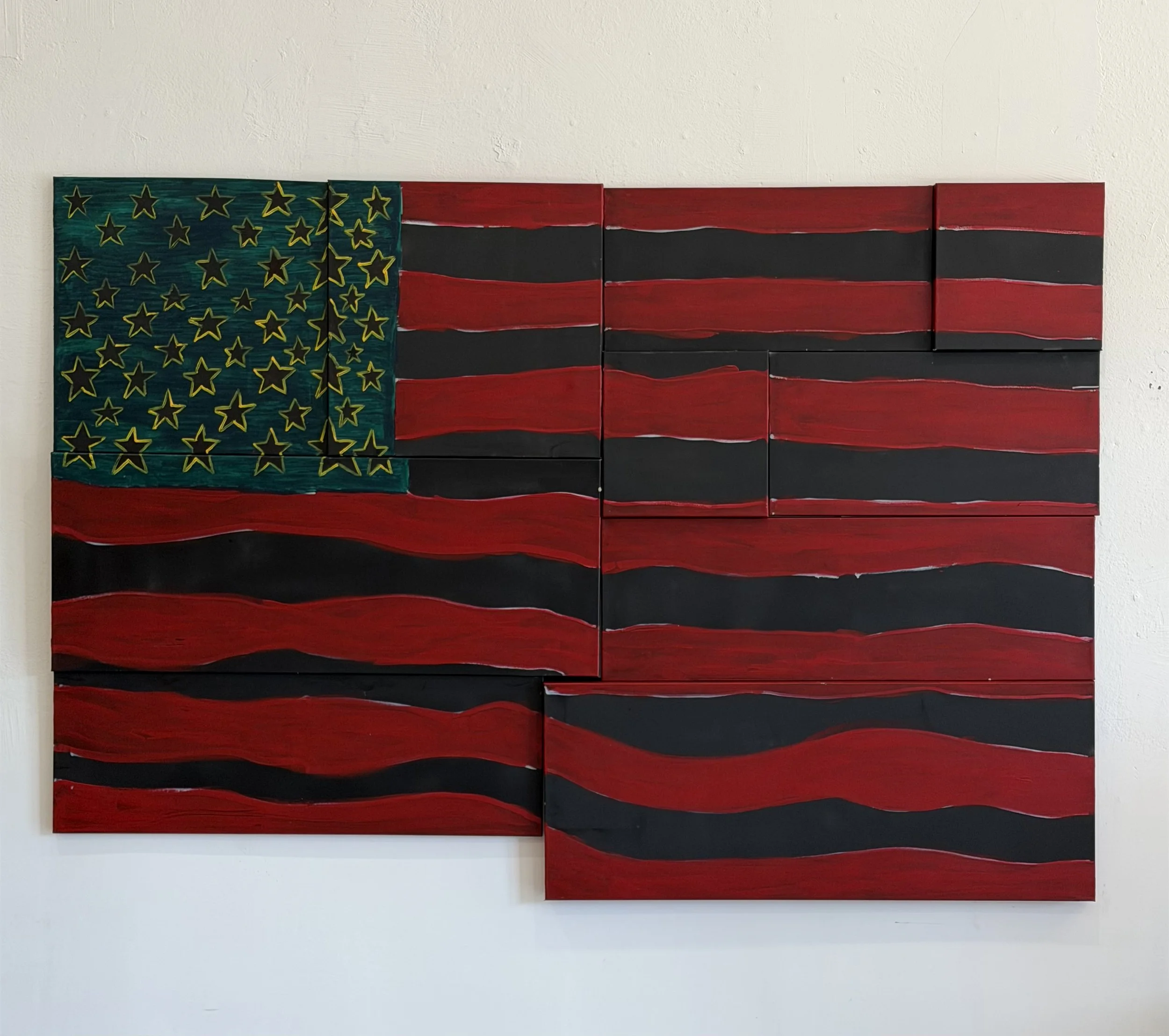 Mixed media artwork resembling the American flag, with a field of yellow outlined black stars and red and black stripes on rectangular panels.