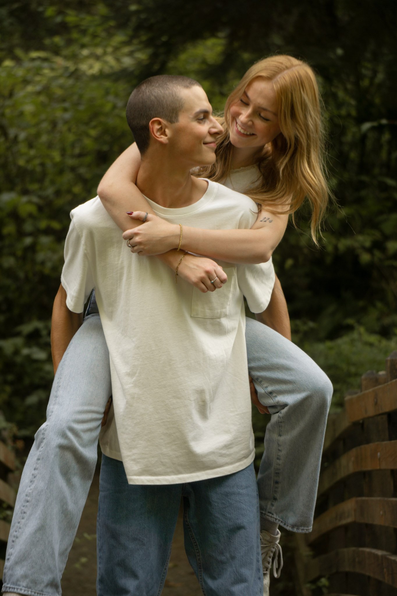 A girl on boys back laughing and smiling together
