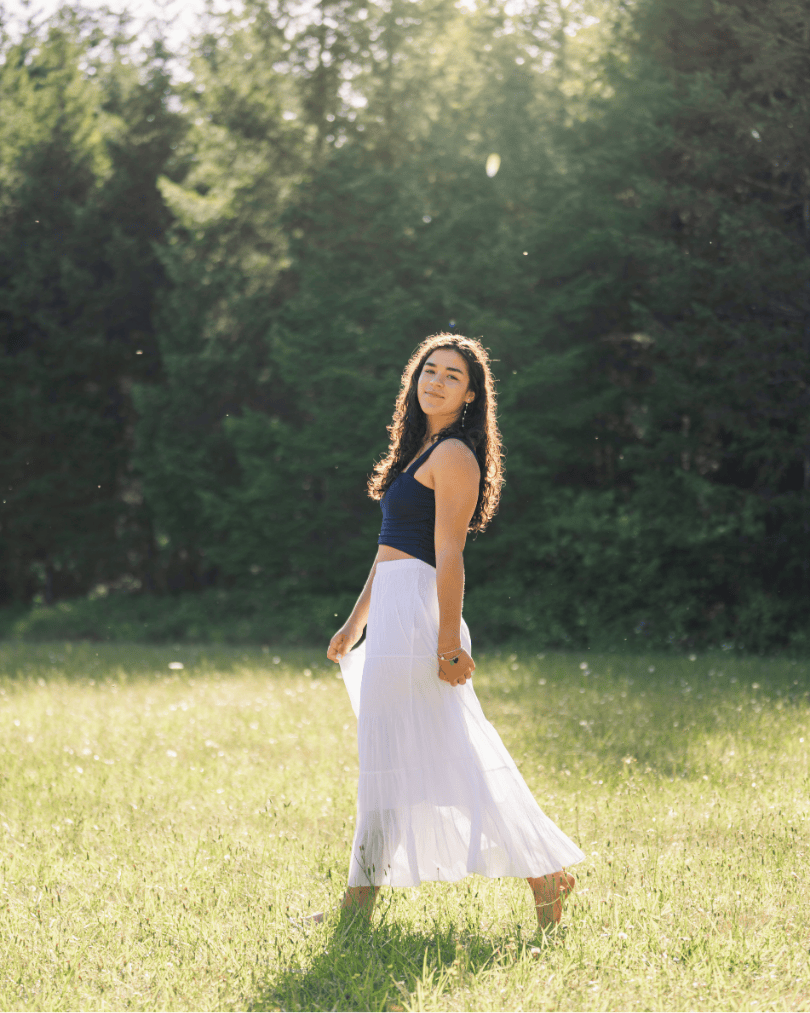 Woman frolicking in a meadow barefoot