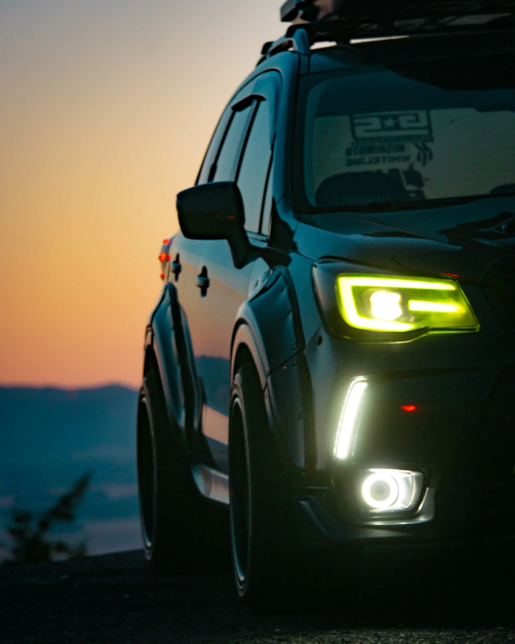 Detail shot of sub headlights on mountain top at sunset