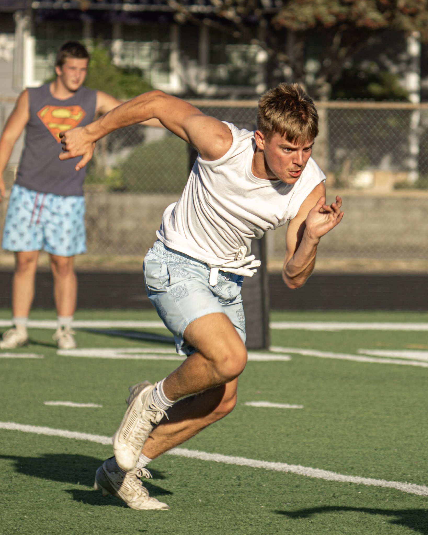 Boy running on turf field at football practice
