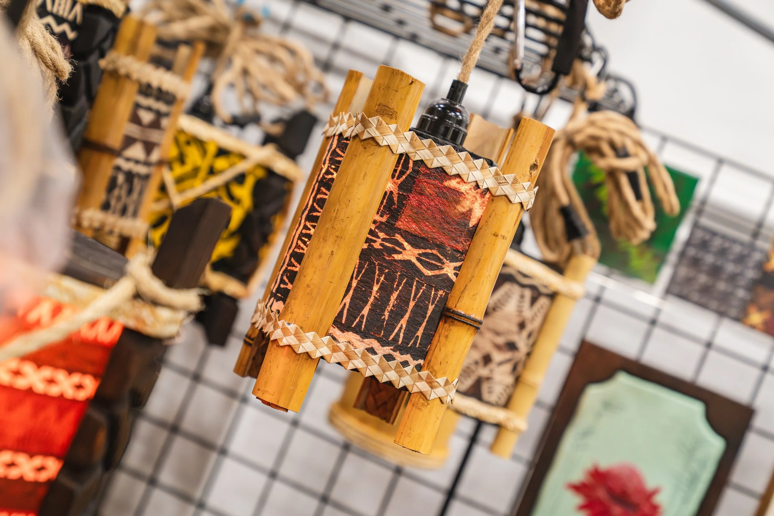 Traditional wooden masks with intricate carvings and designs displayed on a rack.