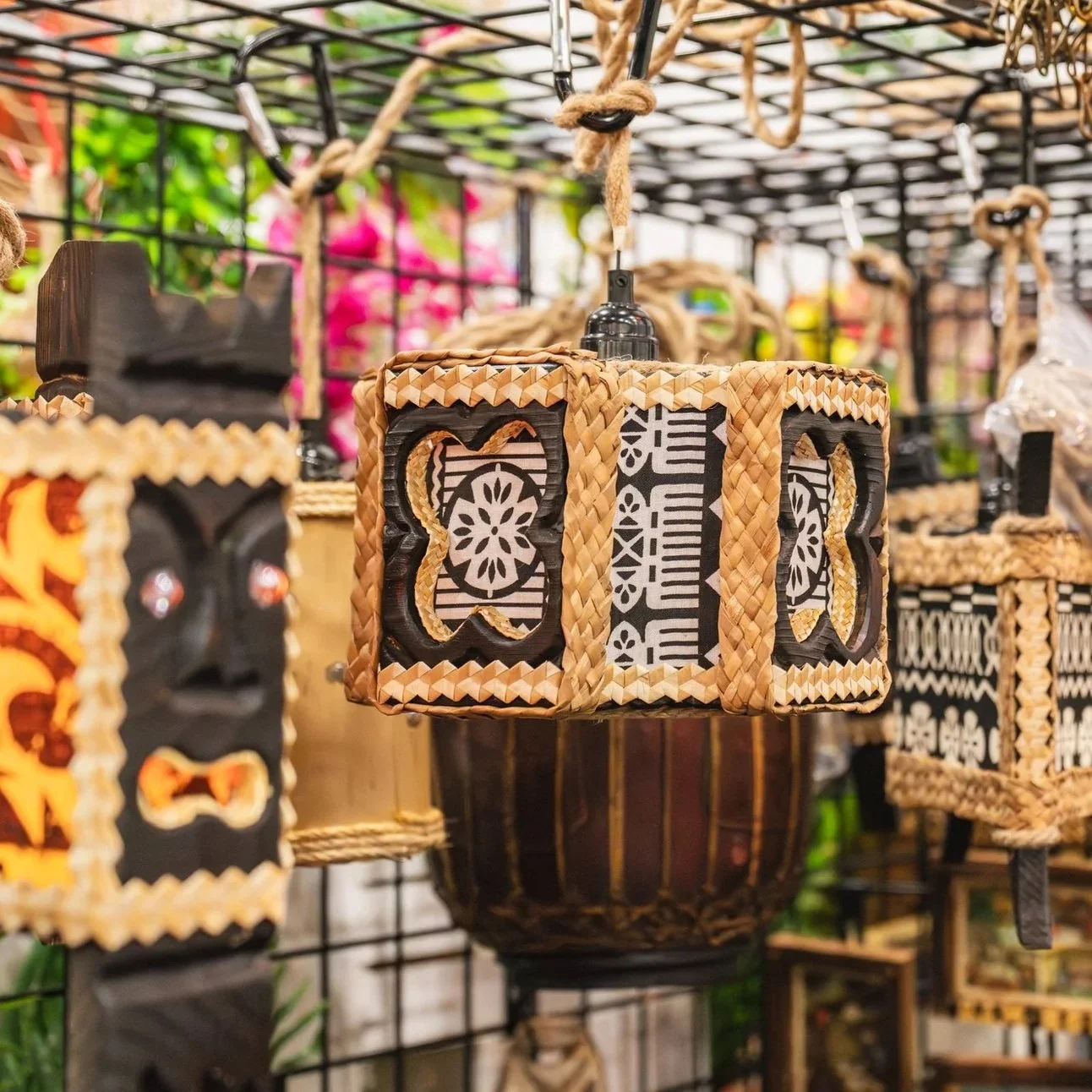 Colorful decorative lanterns with intricate cutout designs, hanging on display.
