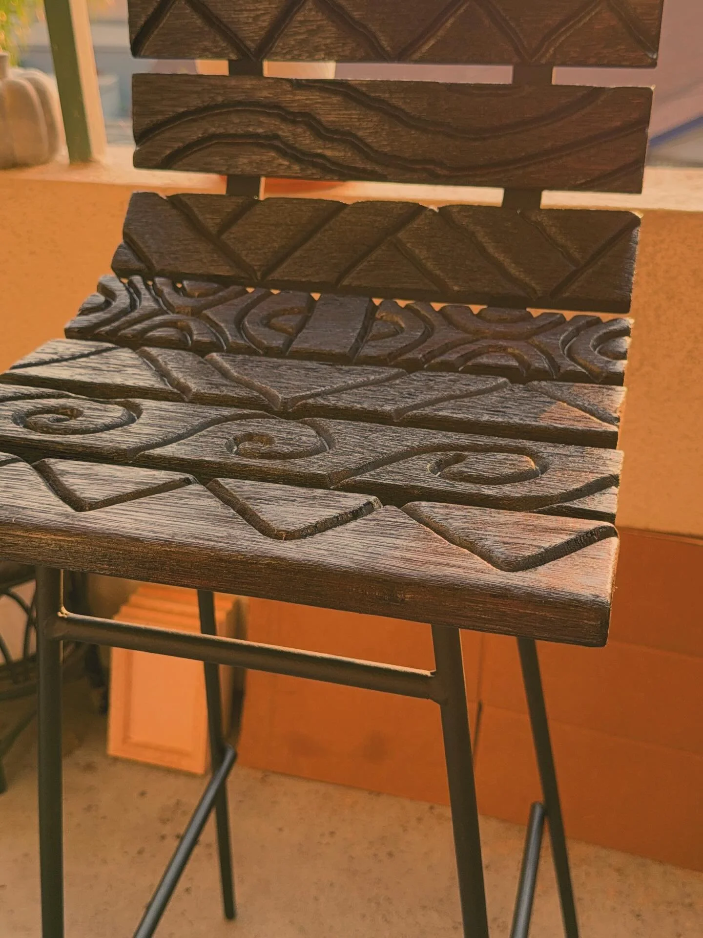 Close-up of a wooden table with decorative metalwork.