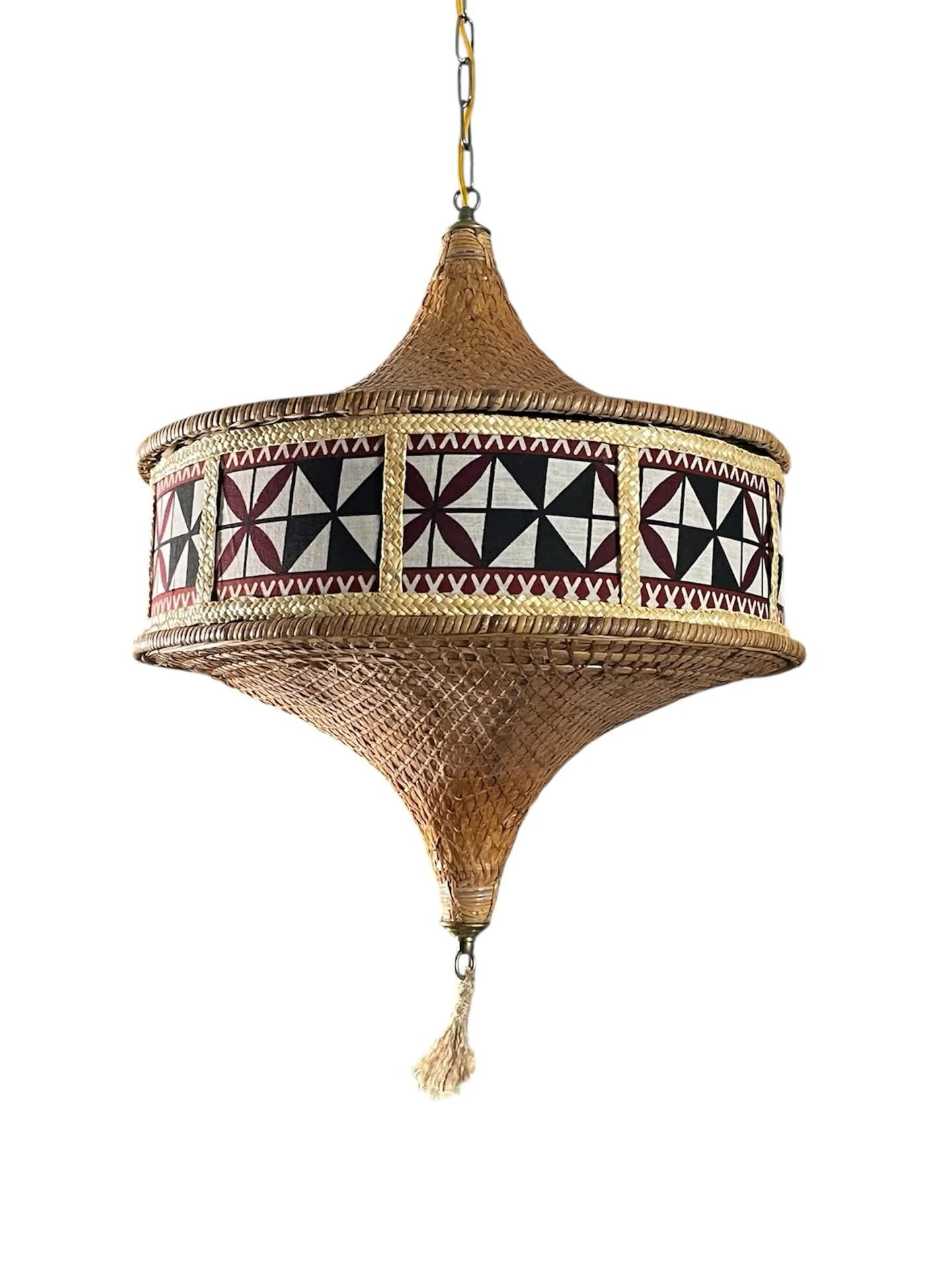 Hanging woven lampshade with geometric pattern in black, white, and red, featuring a tassel at the bottom.