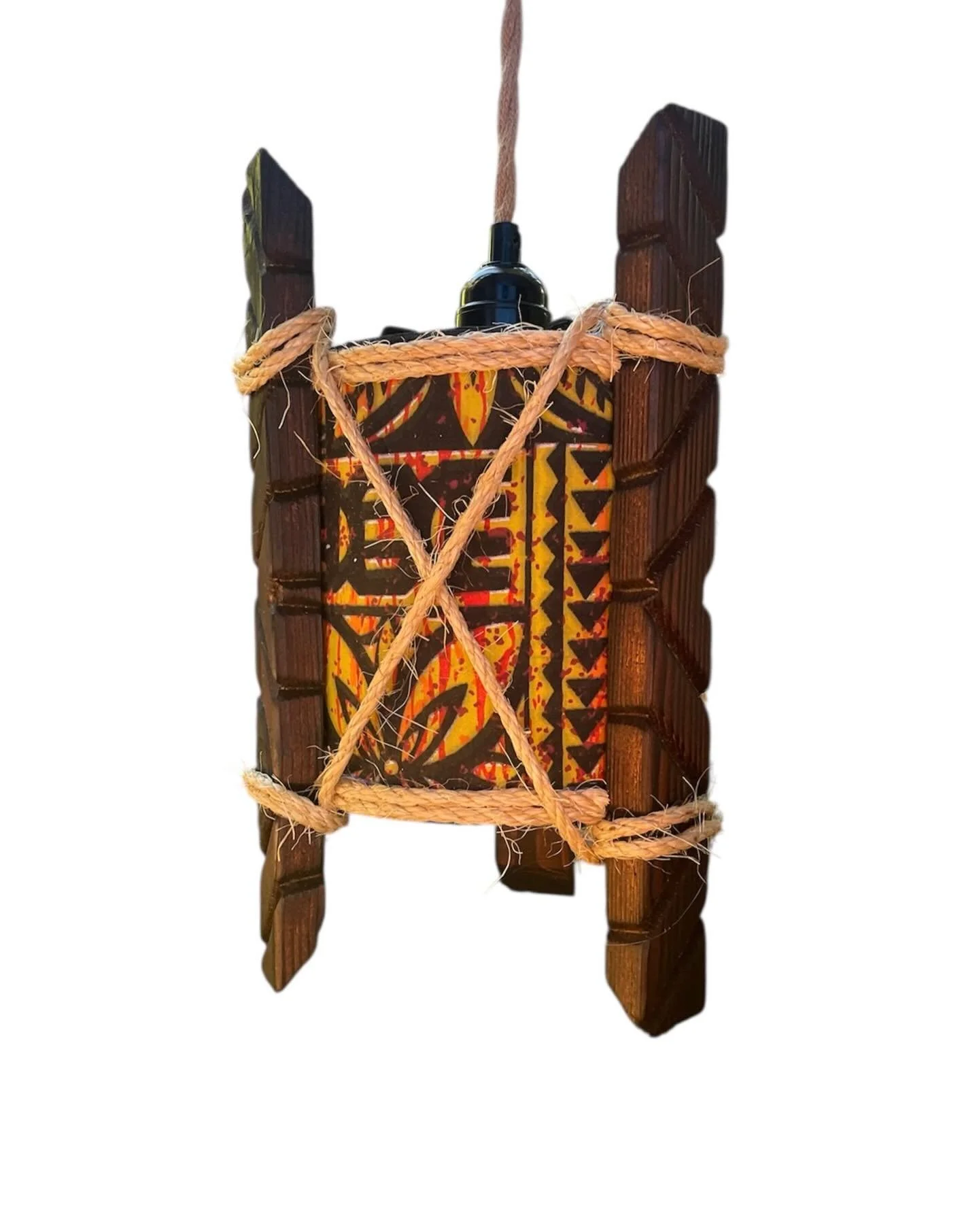 A tribal-style wooden chair with a colorful fabric cushion tied with rope.