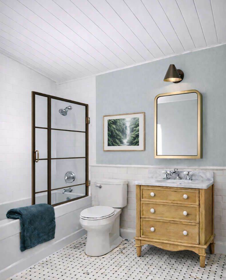 Bathroom with a shower, toilet, wooden vanity with a marble countertop, mirror, painting of a forest scene, and a wall-mounted light fixture.