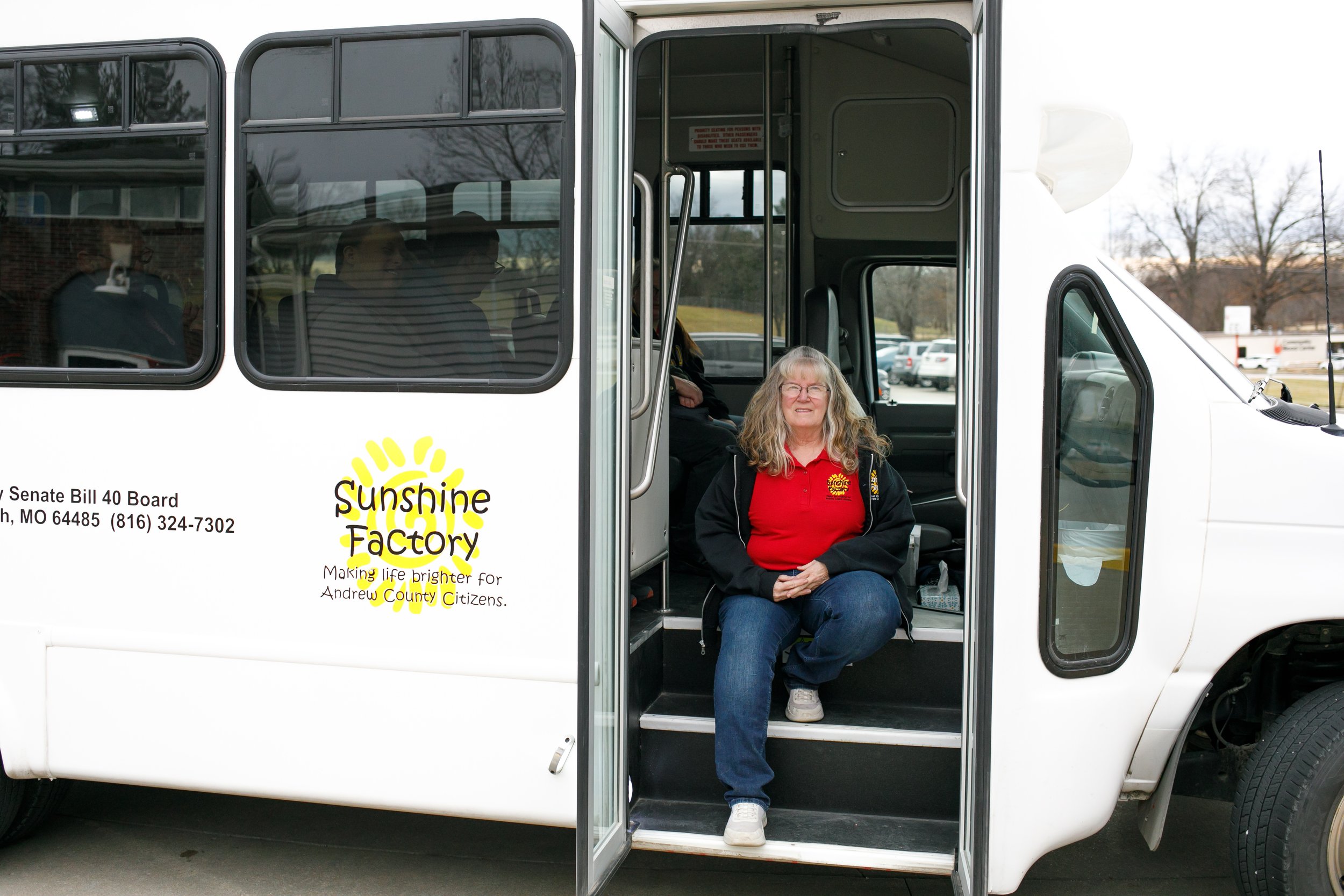 Female driver sitting on Sunshine Factory bus steps