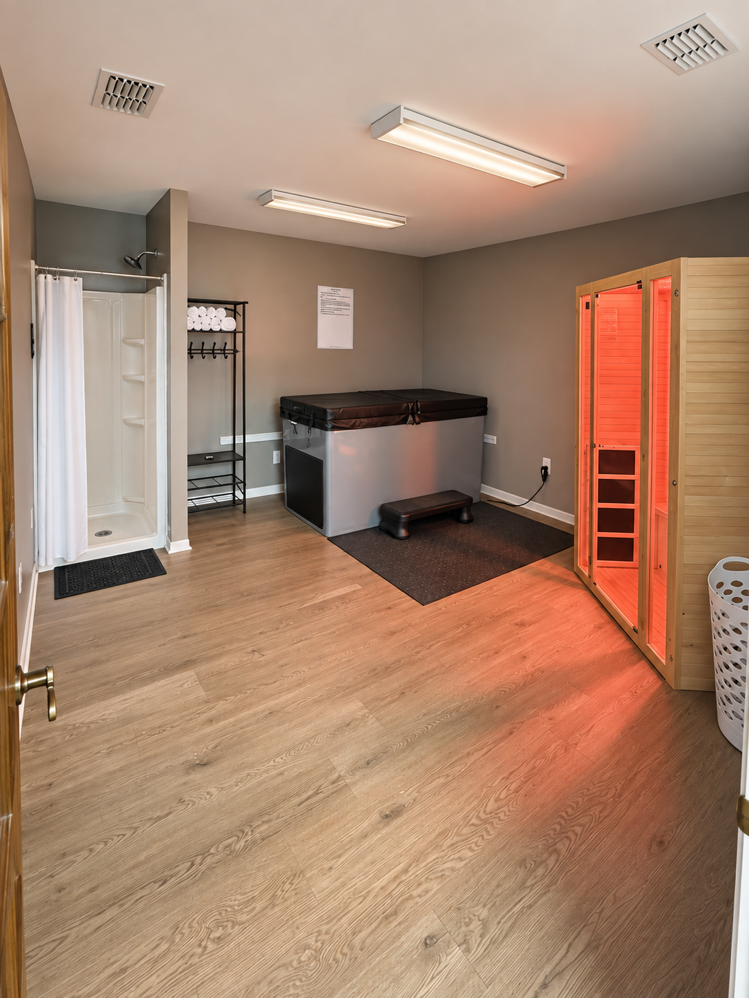 Private contrast therapy suite with infrared sauna, cold plunge and shower at Restful Knights in Crestview, Florida