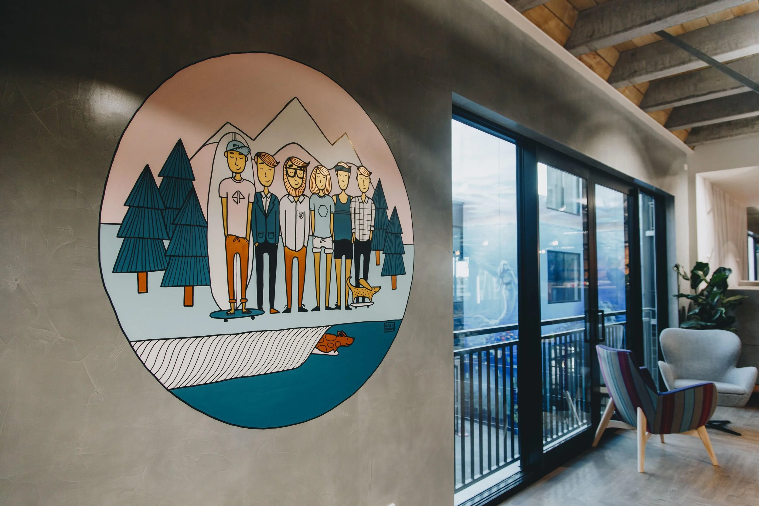 Colorful wall art of six people in a mountain landscape with trees, a river, and a small dog, in a modern interior space.