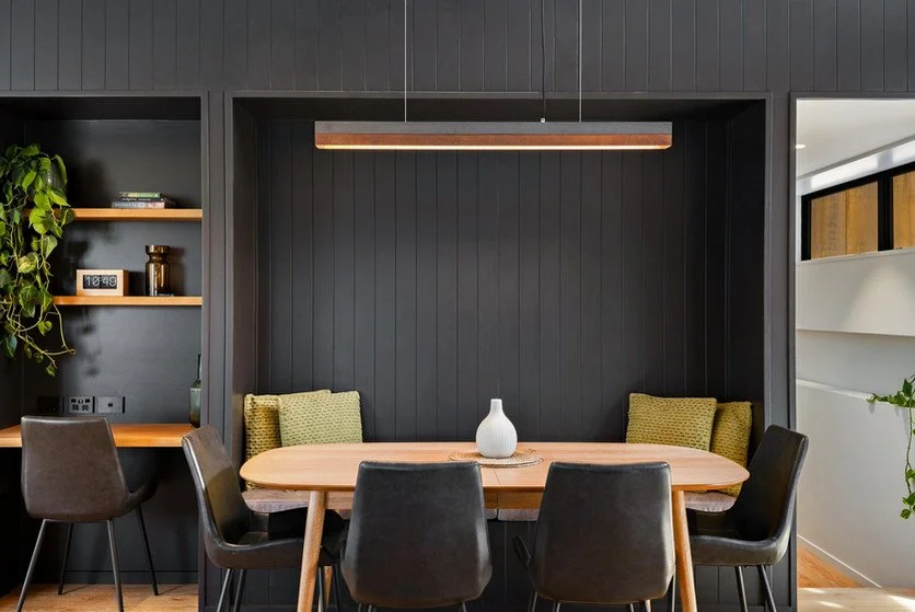Close-up of light wood kitchen cabinets with a black electronic device on the left