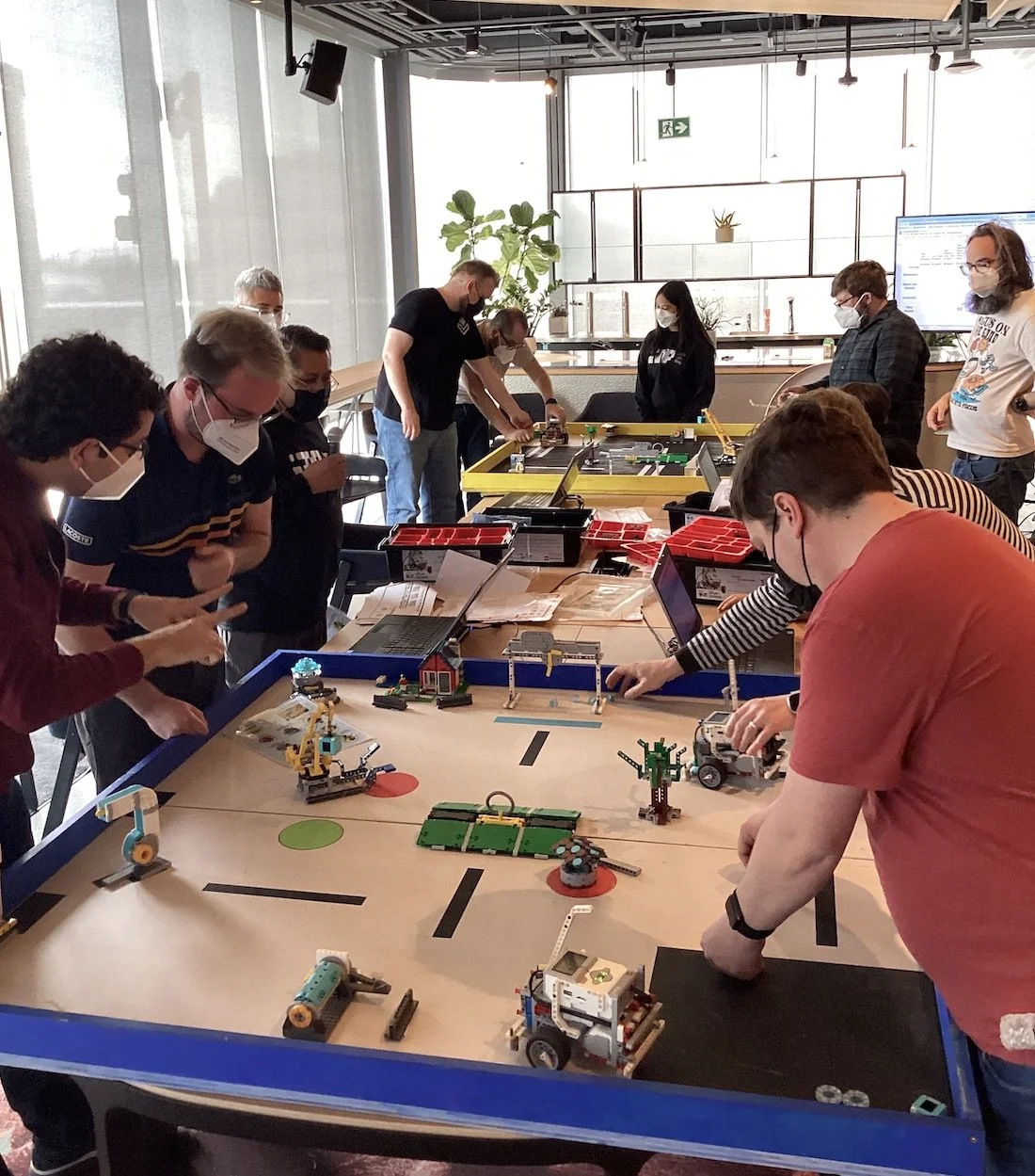 Teams working together around the robotics challenge table