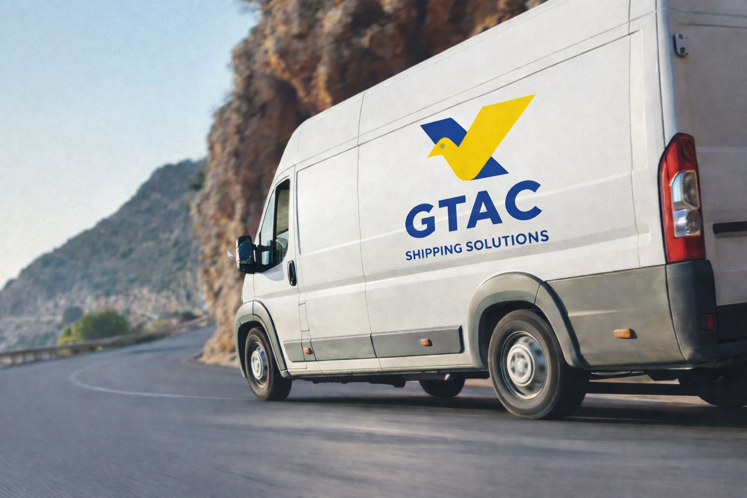 A white delivery van with GTAC Shipping Solutions logo driving on a curved mountain road during daytime.