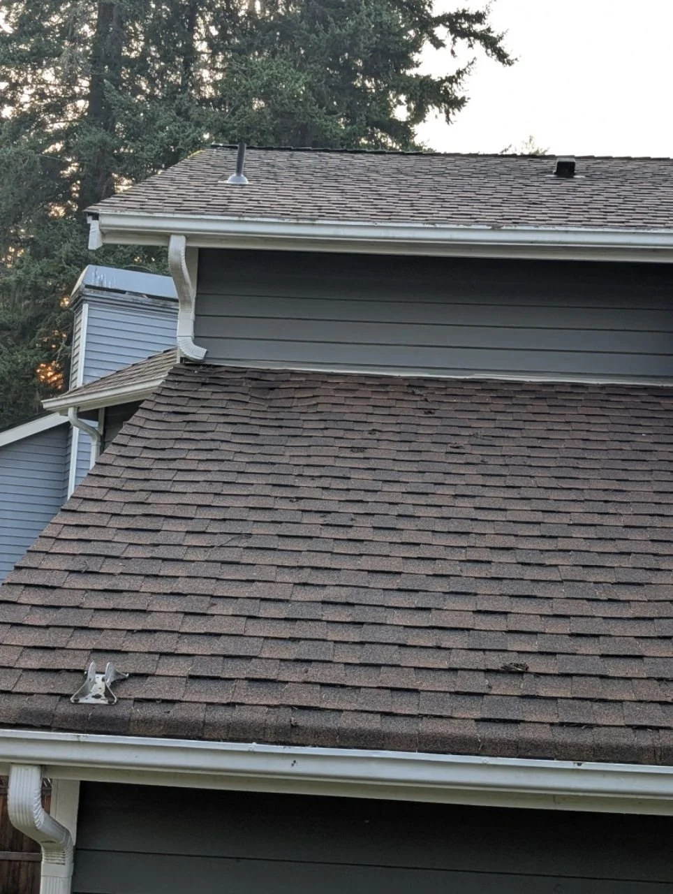 Upper Downspout dumping onto a lower composition roof