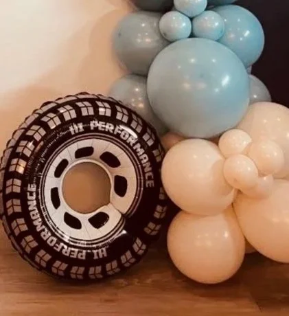 checkered patterns and tire accents, adding a layered, three-dimensional pop to the balloon installation.