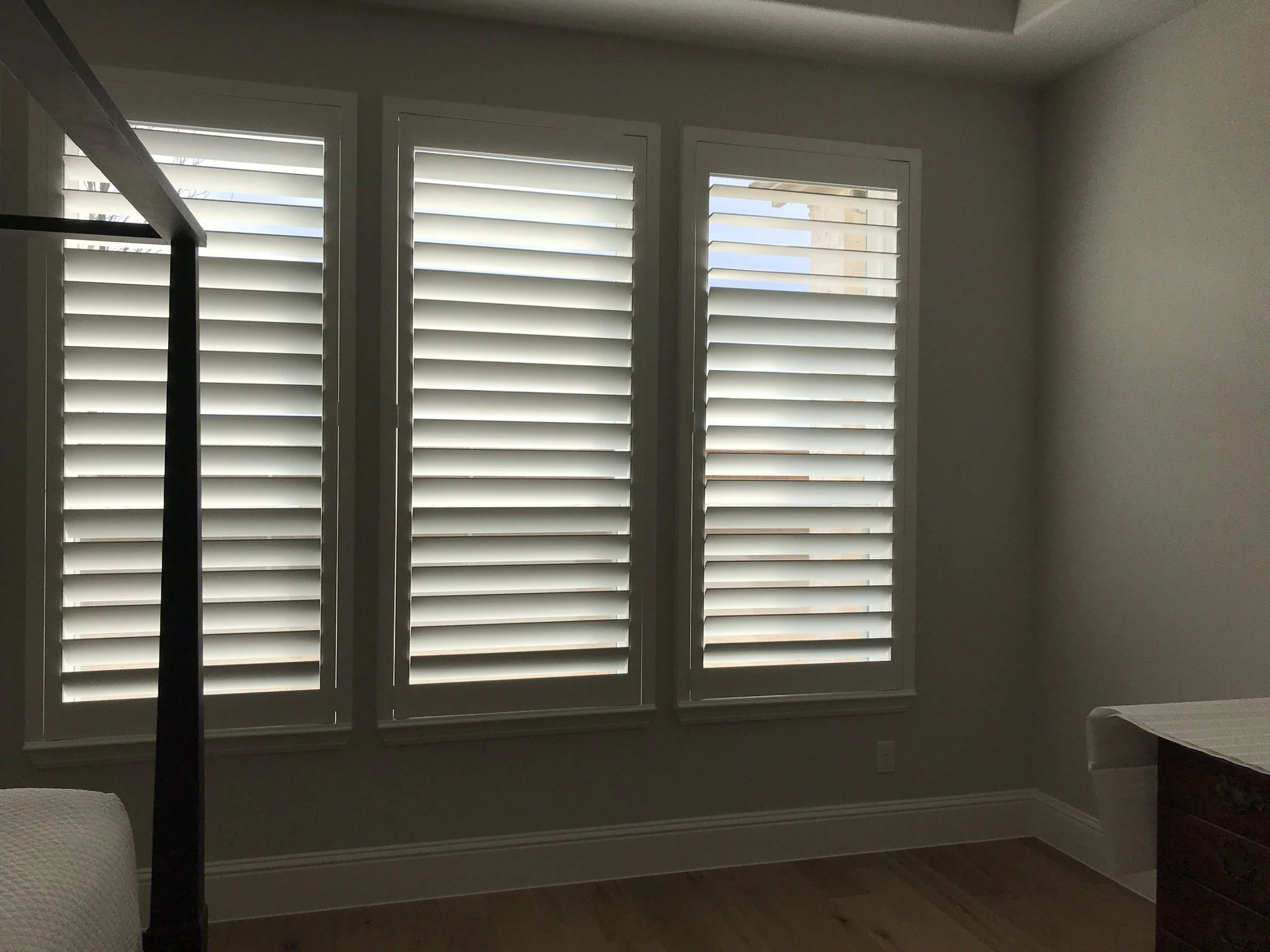 Wood shutters with Clearview (no tilt rod), 4.5" louvers, painted SW 7006 Extra White, flat master frame, split at top to leave 3 or 4 louvers, outside mount.