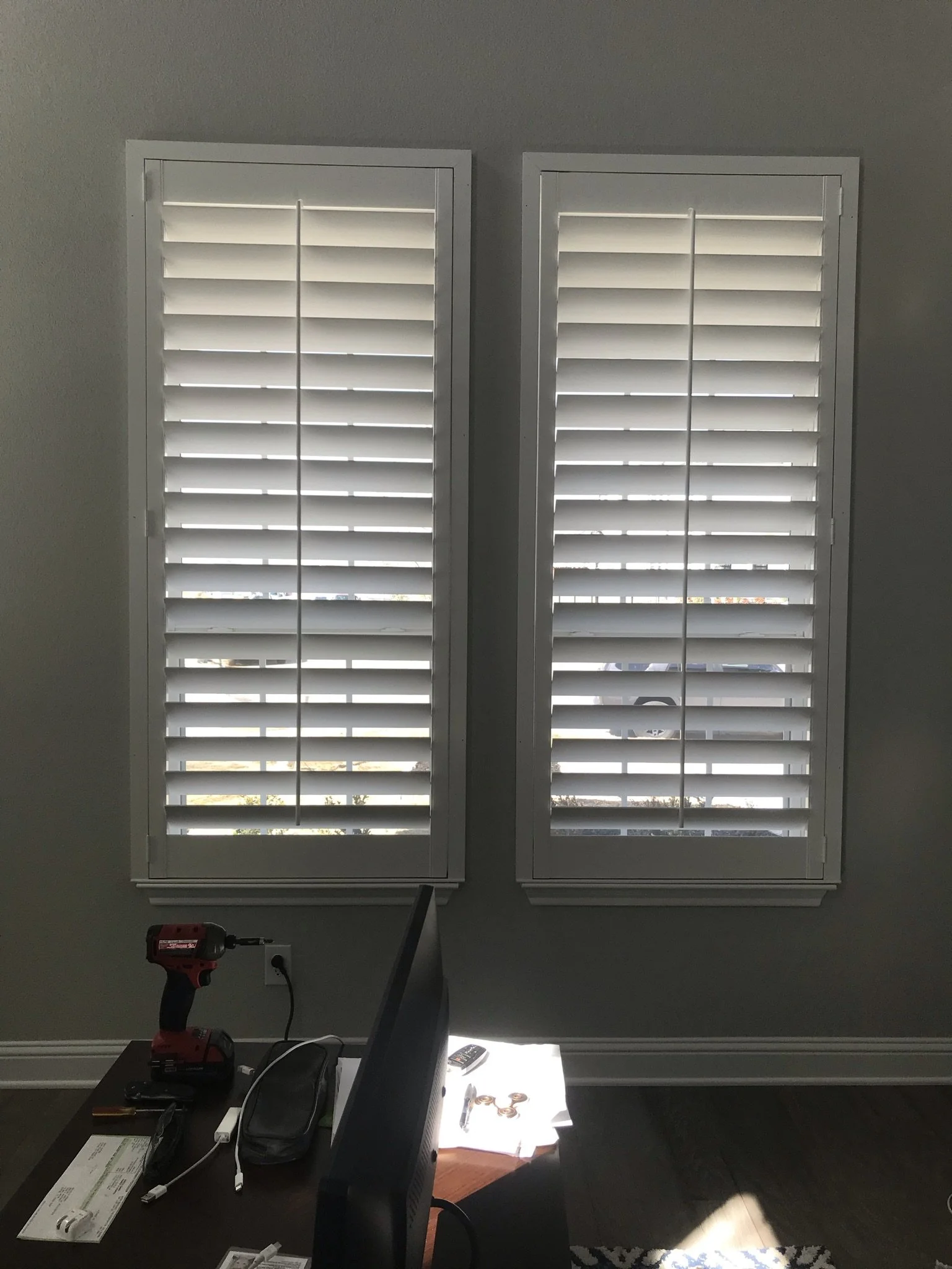 Custom wood shutters with front tilt rods, 4 1/2" louvers, painted, divider rail.