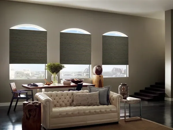 Three arched windows with Hunter Douglas Provenance Woven Wood shades, waterfall fold, Telluride fabric, with room darkening liner and LiteRise (cordless).