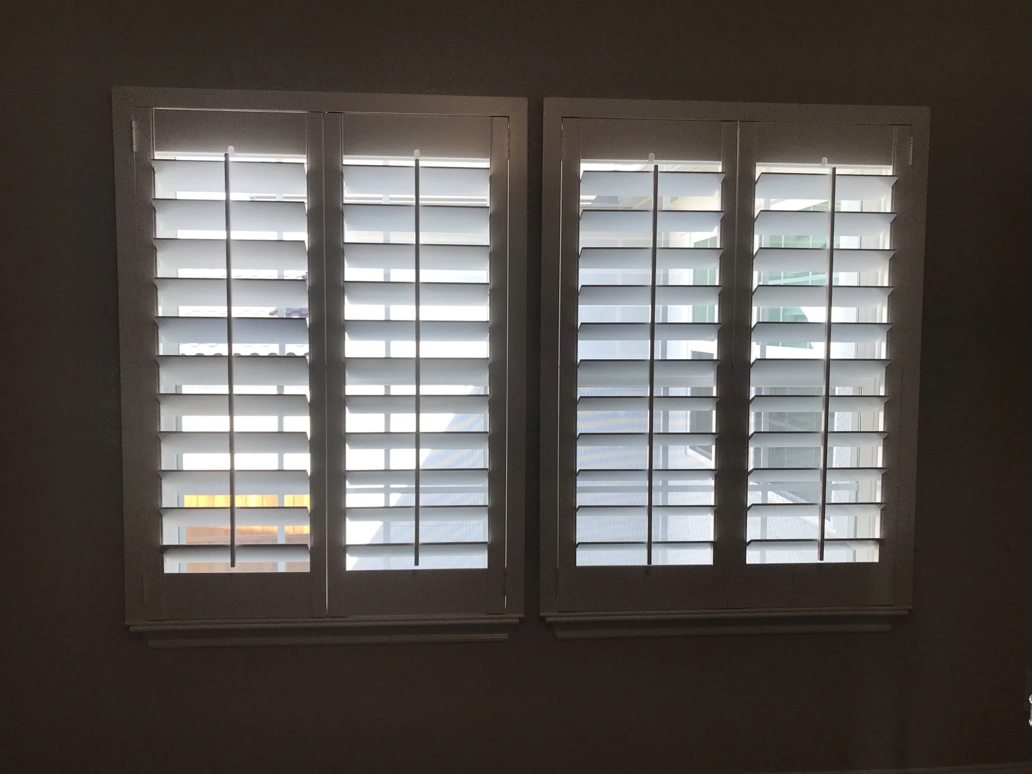 Custom wood shutters with front tilt rods, 4 1/2" louvers, painted, no divider rail.