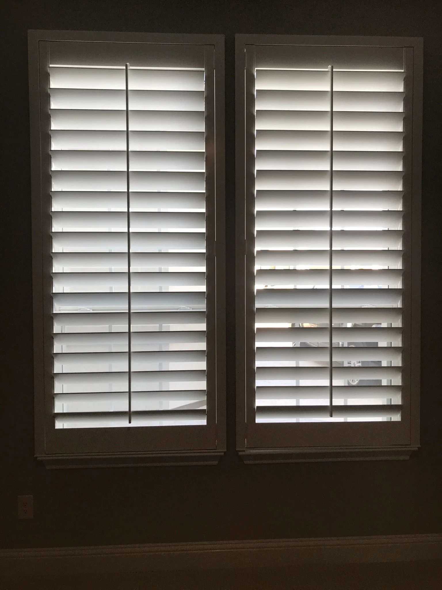 Custom wood shutters with front tilt rods, 4 1/2" louvers, painted, no divider rail.