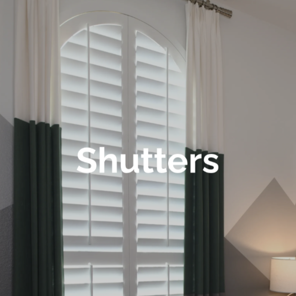 A window with white plantation shutters, 4 1/2" louvers with front tilt rods and divider rails at the sash.  2 panels, eyebrow arch top.