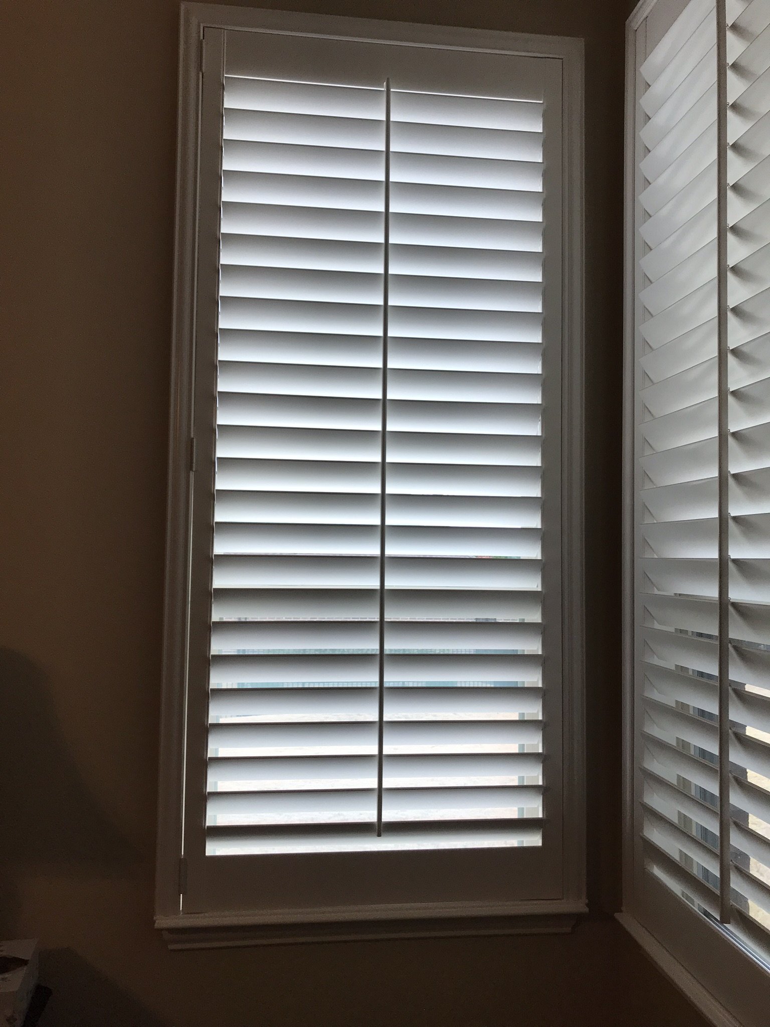 Custom painted wood shutters, 3 1/2" louvers, front tilt rod, painted alabaster to match sills, 1 panel, master frame.