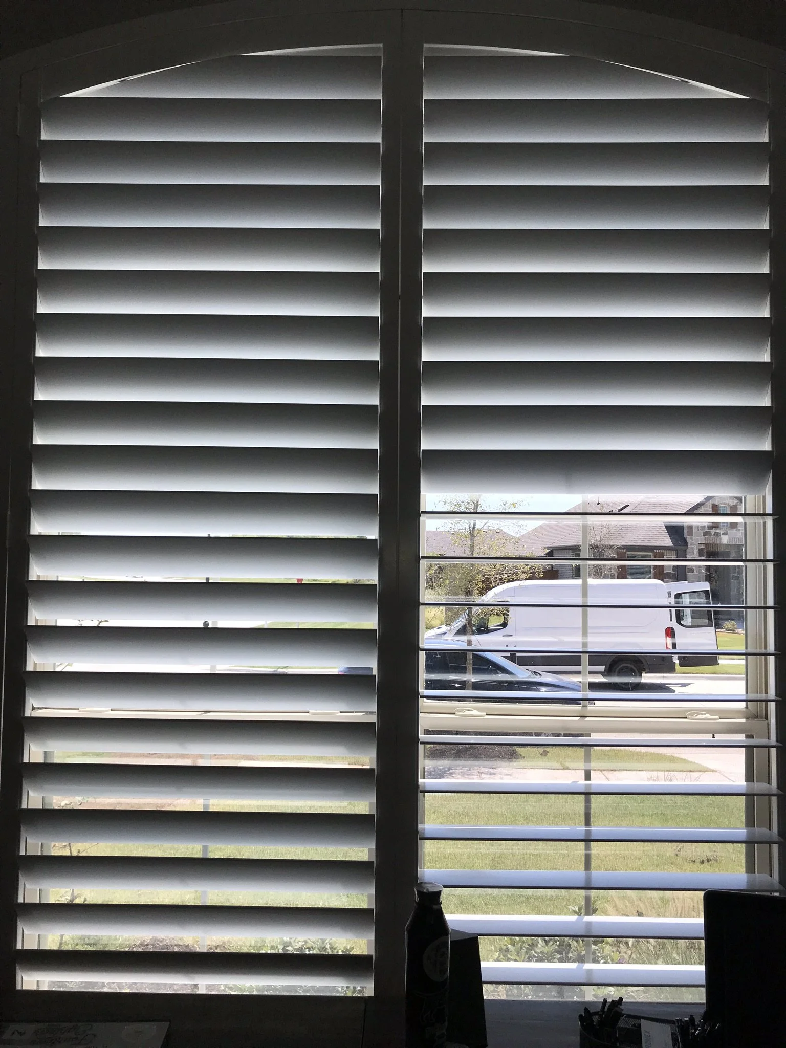 Wood shutters with rear hidden tilt, 4 1/2" louvers, SW Pure White, no divider rails.  Eyebrow arch top.