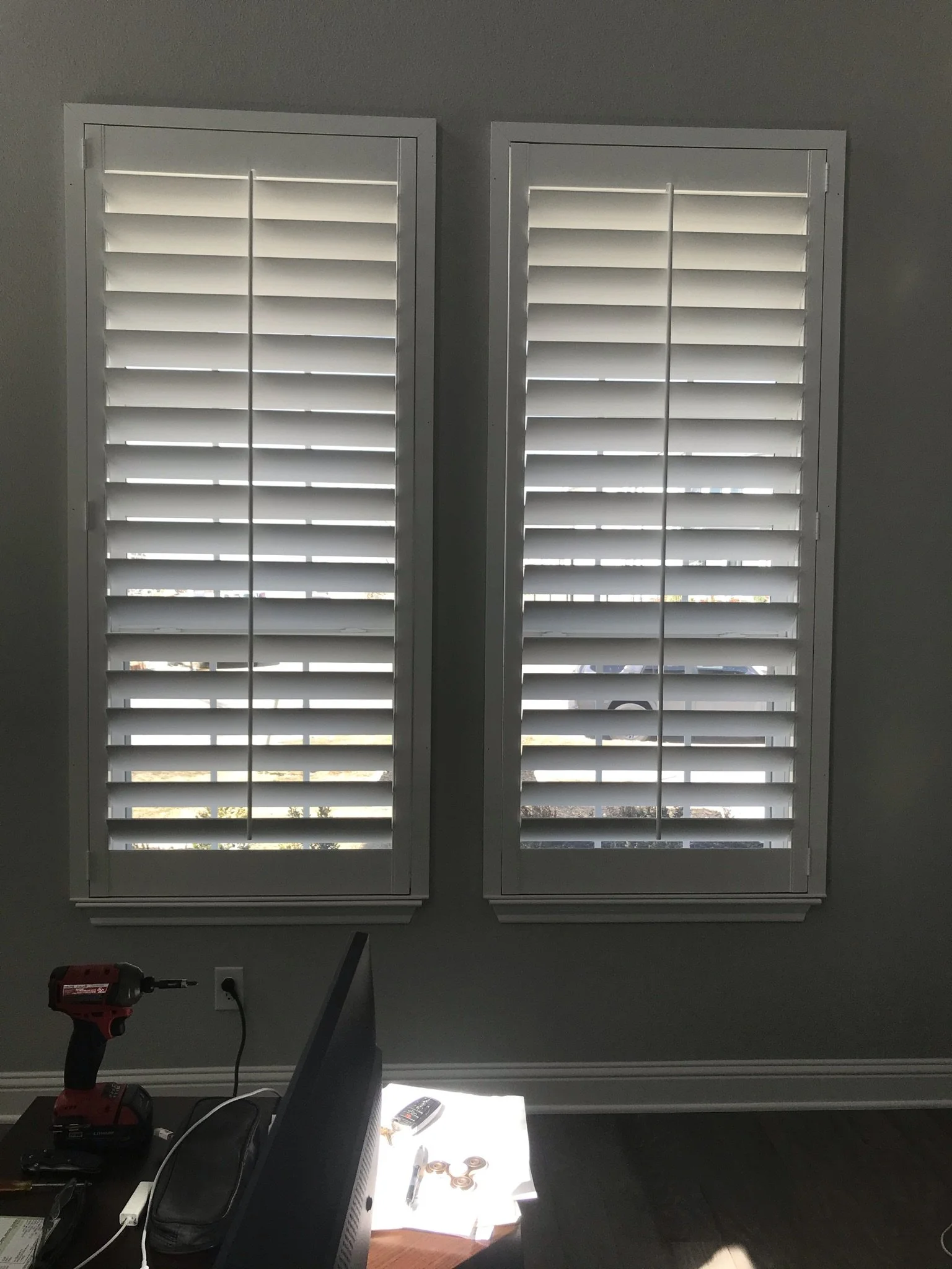 Custom wood shutters with front tilt rods, 4 1/2" louvers, painted, divider rail.