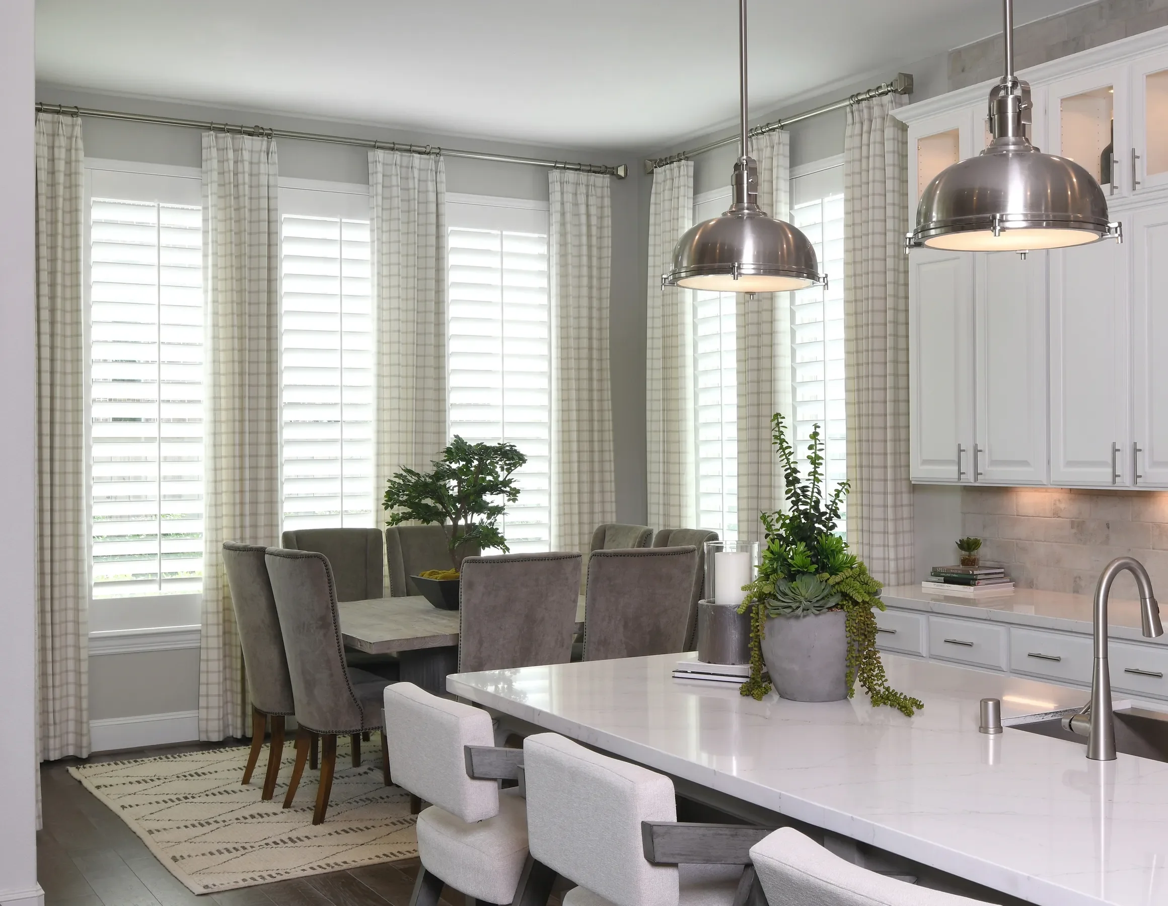 Custom wood shutters with traditional front tilt rod, divider rails at sash, 4 1/2" louvers, painted Sherwin Williams Extra White, painted white hinges.