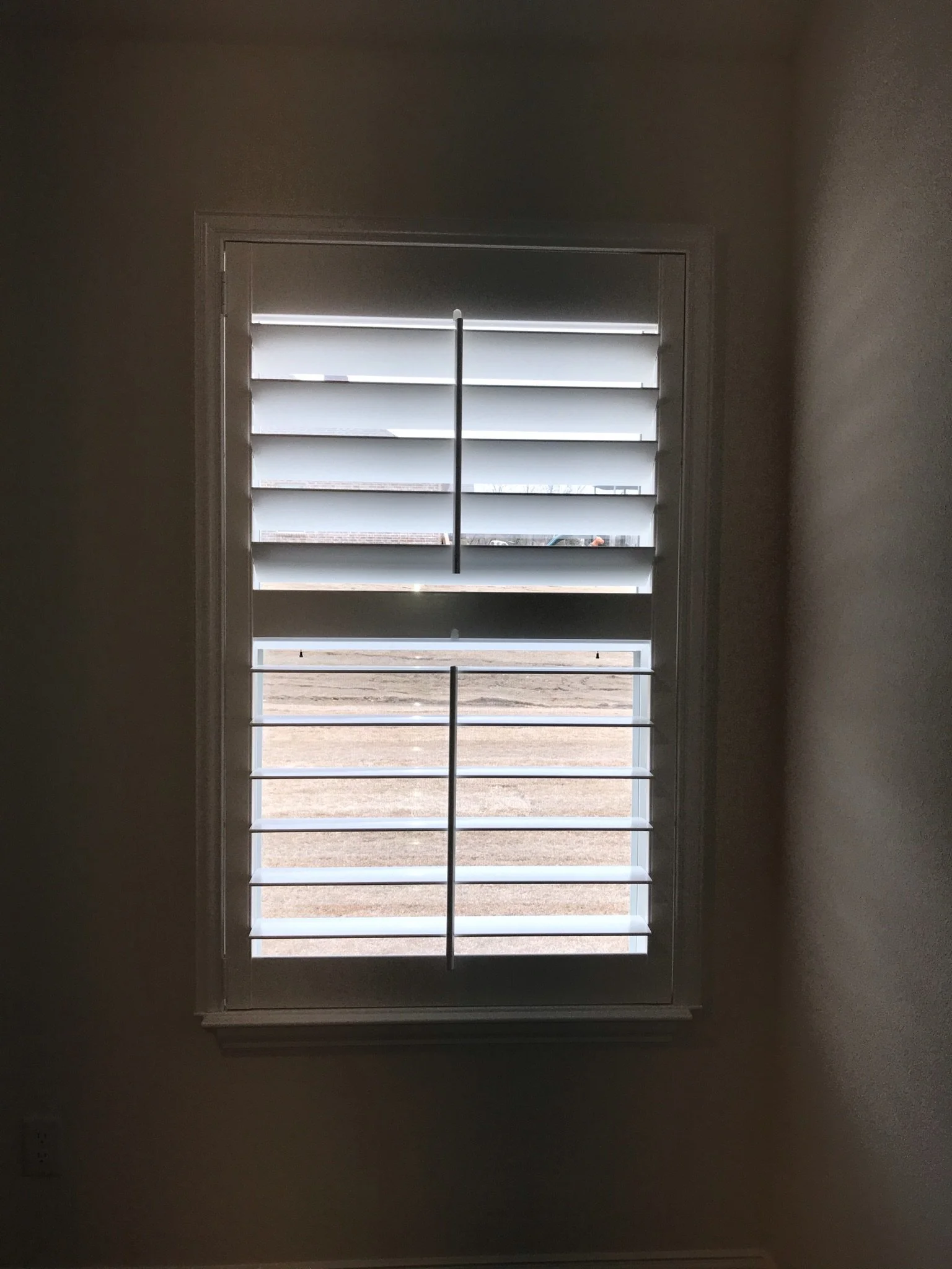 Custom wood shutters with front tilt rods, 4 1/2" louvers, painted, divider rail.