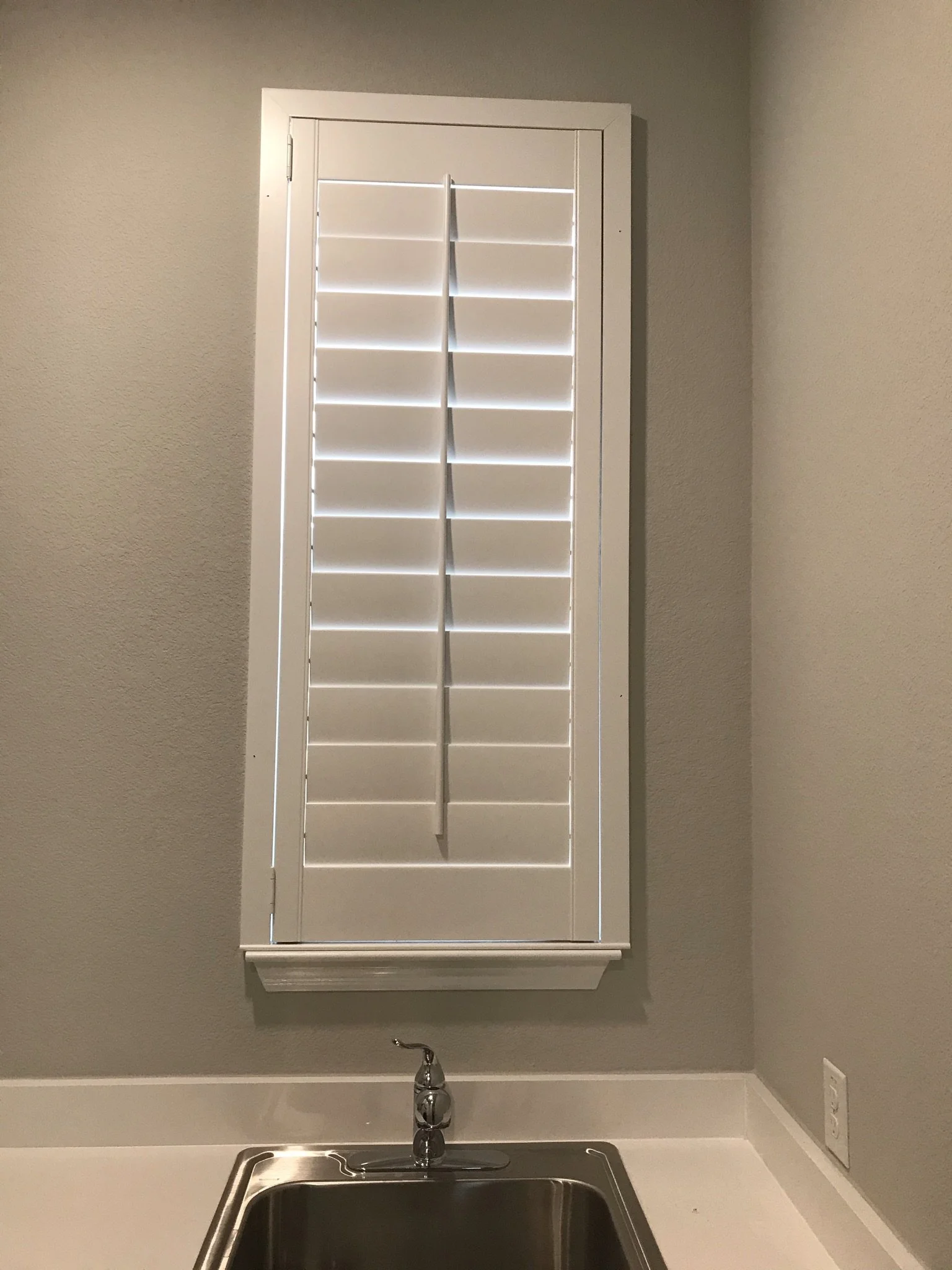 Custom wood shutters with front tilt rods, 4 1/2" louvers, painted, divider rail.