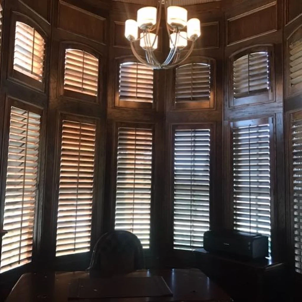 Custom stained wood shutters, 3 1/2" louvers, front tilt rod, custom stain to match wood trim, L frame, eyebrow arches on top.