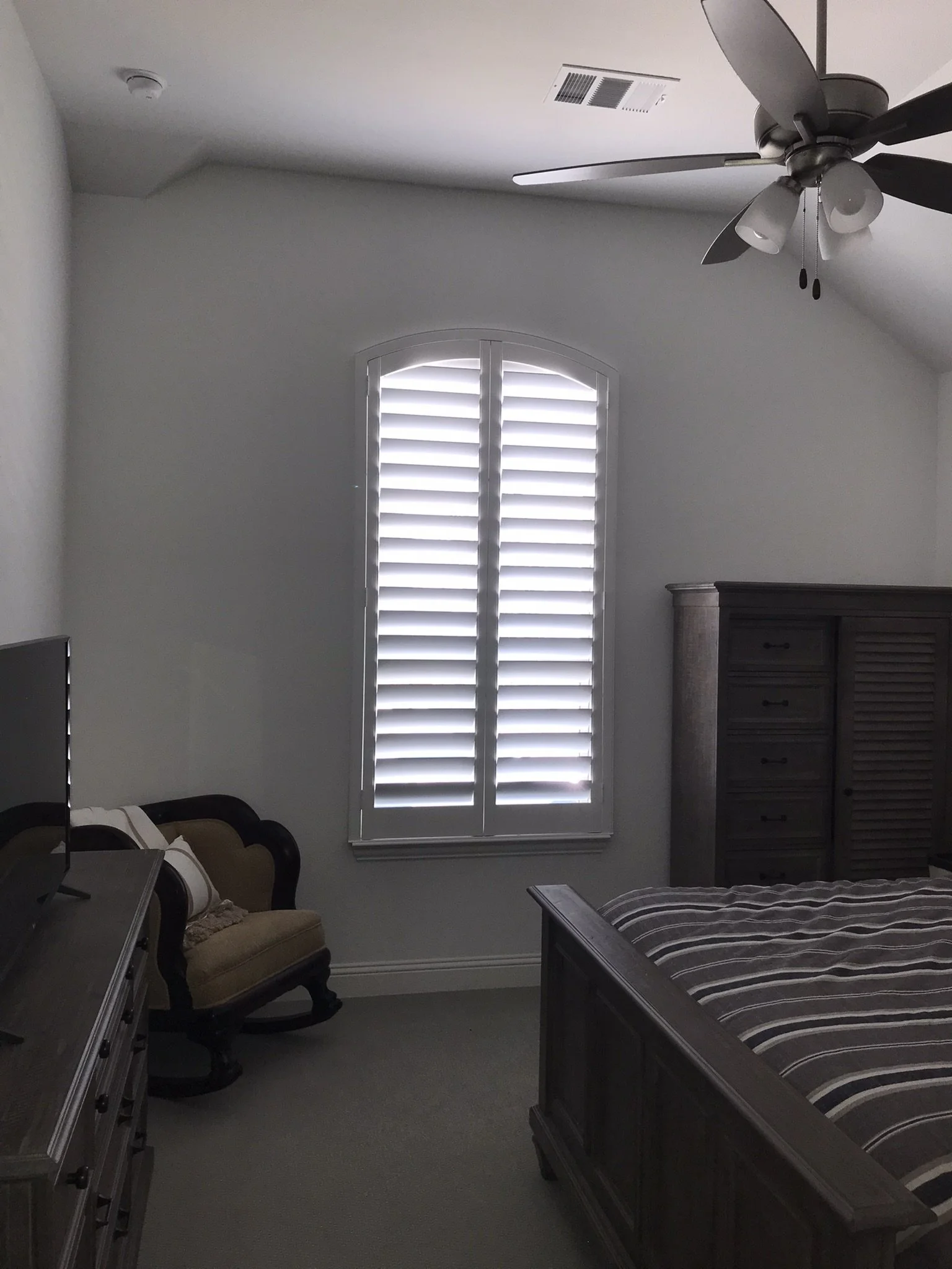Custom wood shutter, eyebrow arch top, 4 1/2" louvers, painted white, 2 panels, no divider rails.