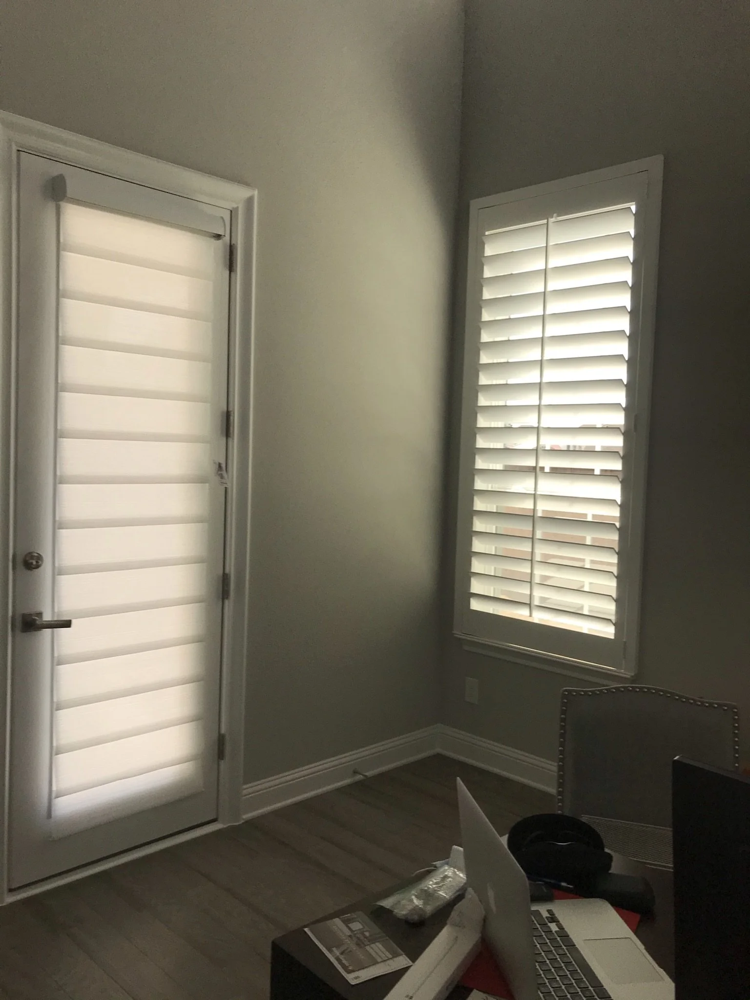 Custom wood shutters with front tilt rods, 4 1/2" louvers, painted, divider rail.