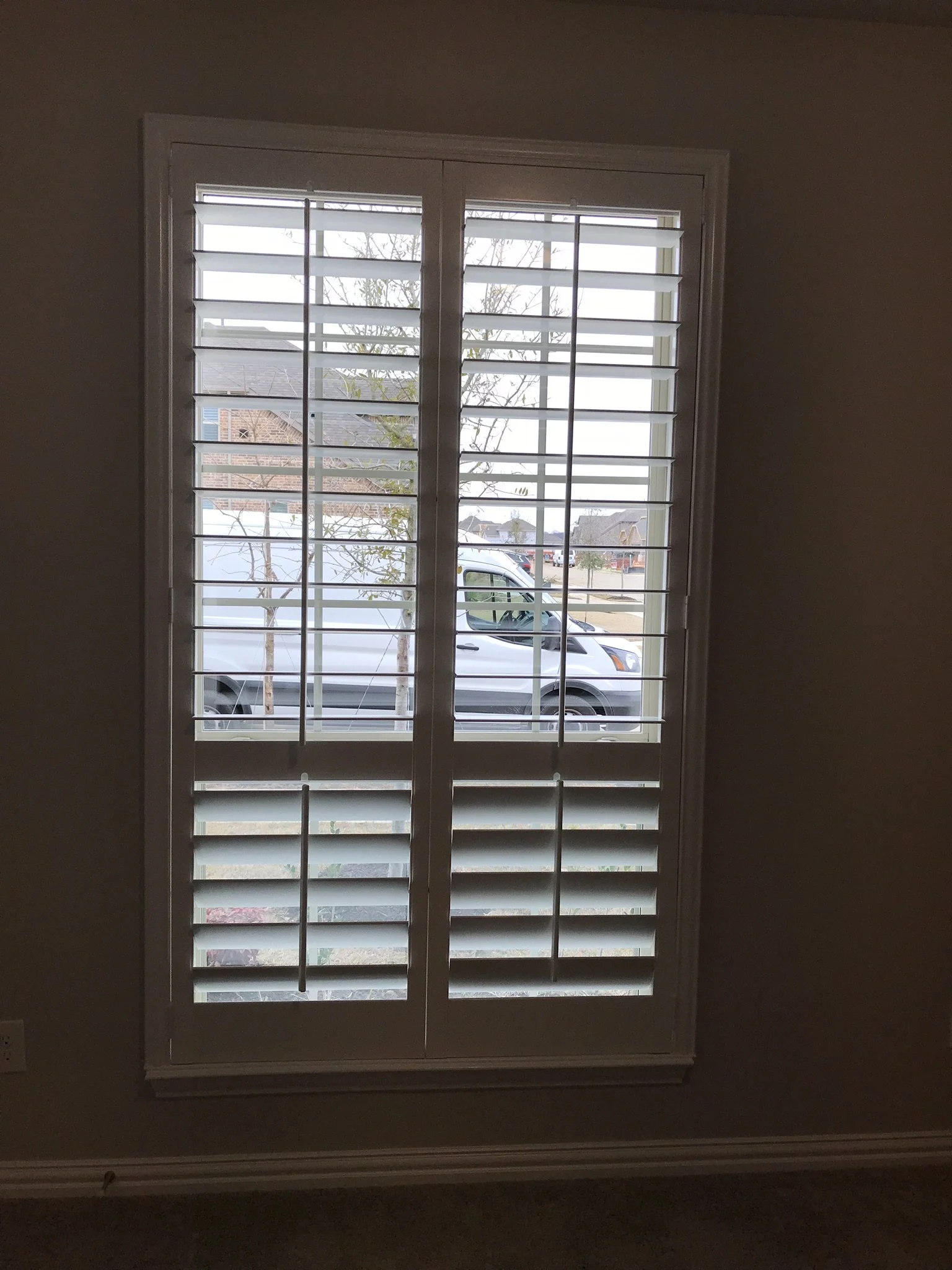Wood Shutters with tilt rods, painted white, flat master frame, divider rails, 2 panels.
