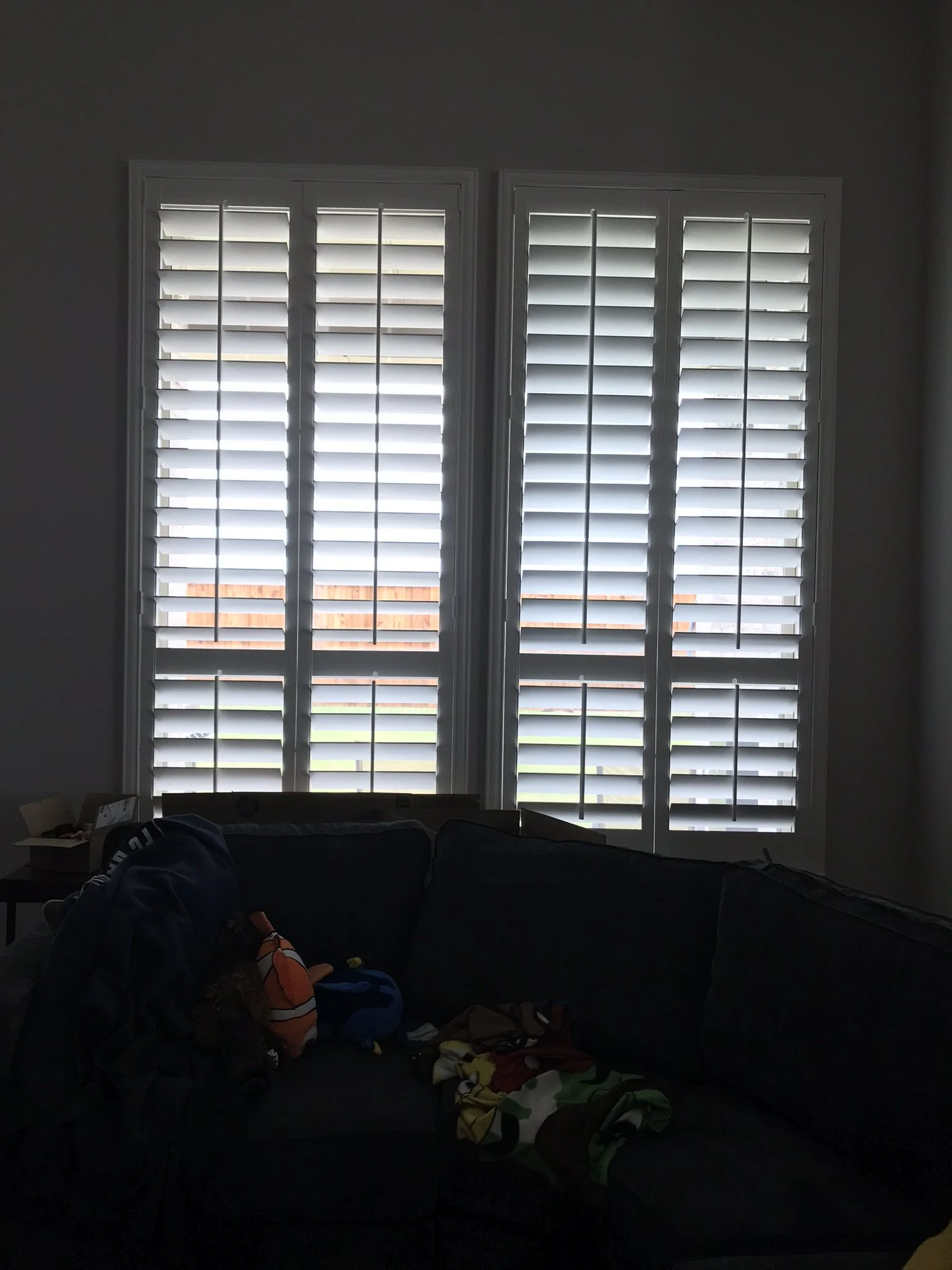 4 1/2" louvers, wood shutters with tilt rods, divider rails at sash, painted.
