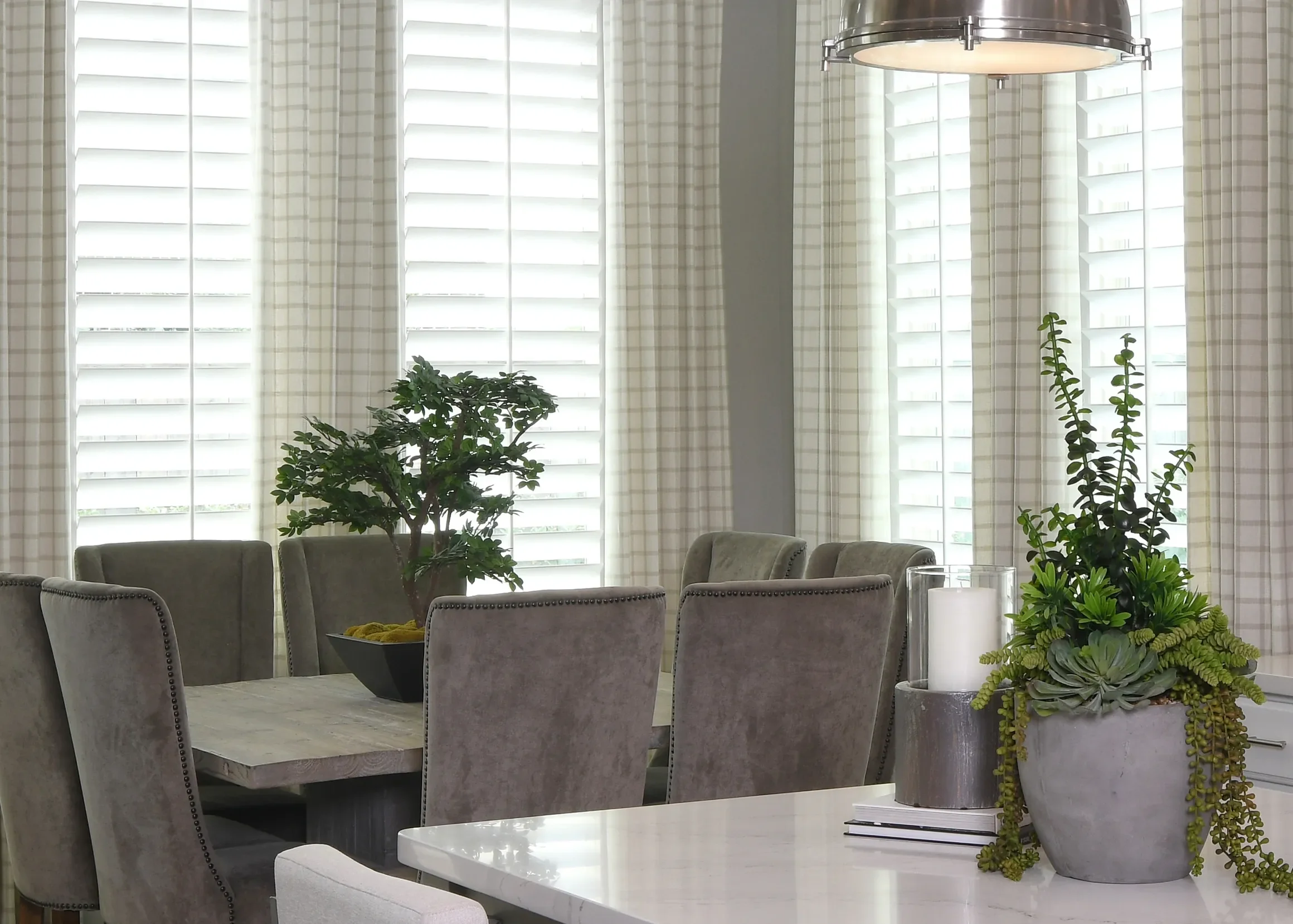 Custom wood shutters with traditional front tilt rod, divider rails at sash, 4 1/2" louvers, painted Sherwin Williams Extra White, painted white hinges.