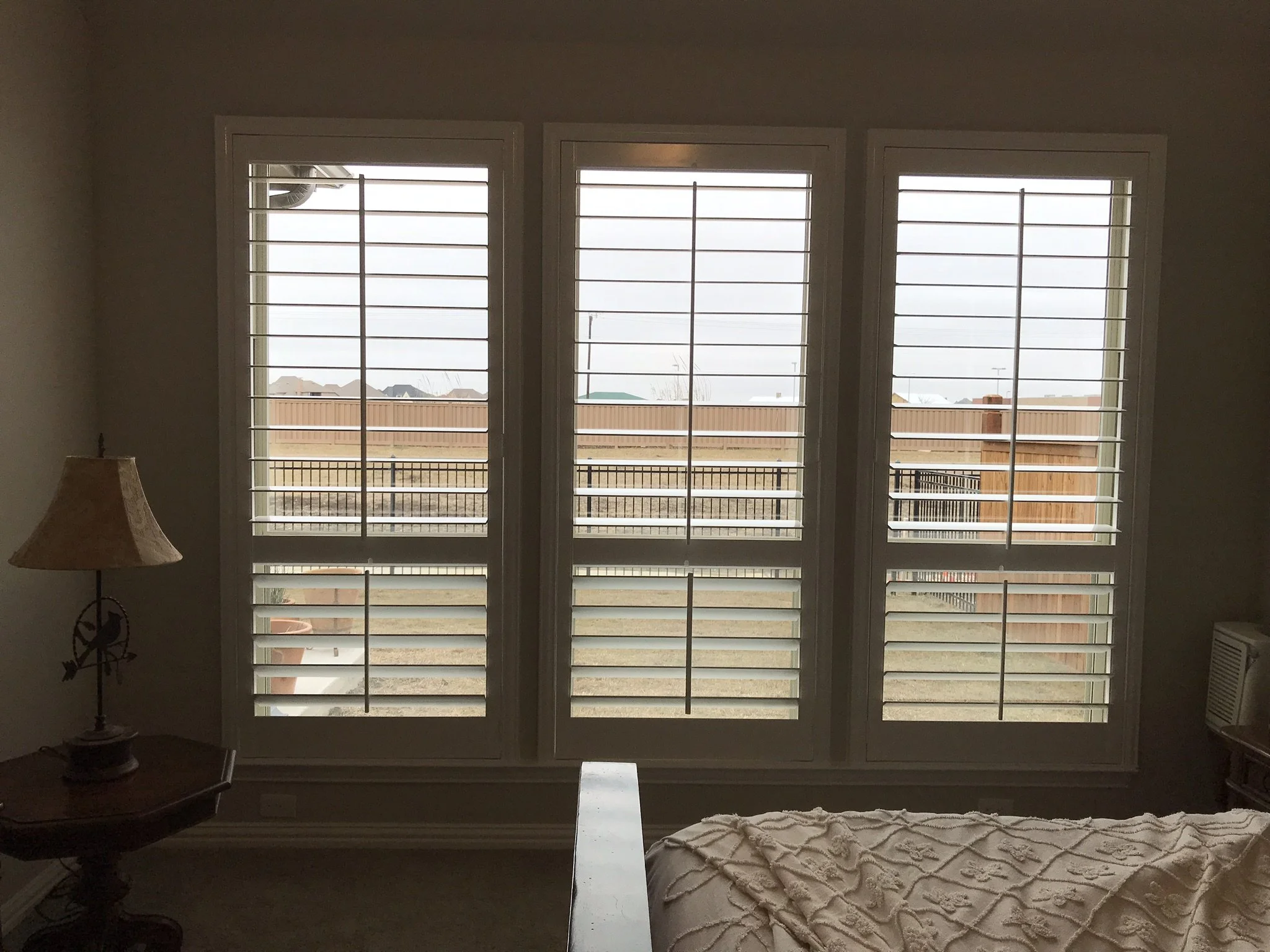 Wood shutters with front tilt rods, 4 1/2" louvers, divider rails @ sash.