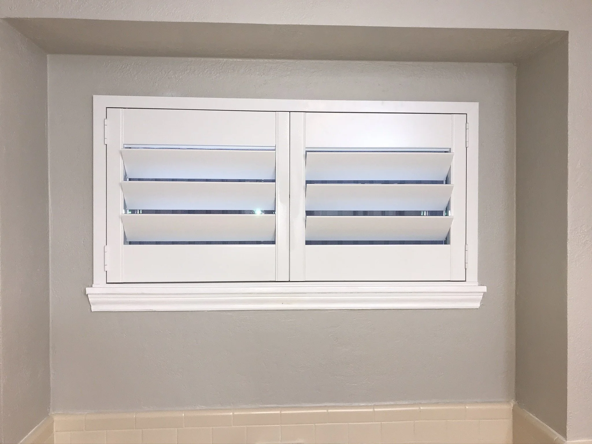 Custom wood plantation shutters with clearview (rear hidden tilt), 4 1/2" louvers, painted SW Pure White semi-gloss, 1.5" flat master frame and Z frame, no splits.  2 panel.